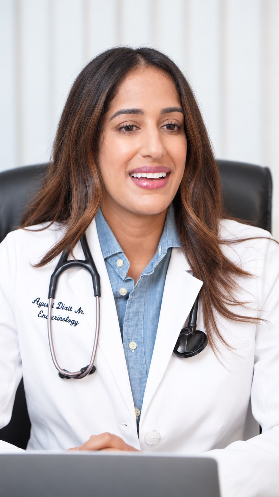 Dr. Ayushi Dixit, endocrinologist, smiling in her white coat