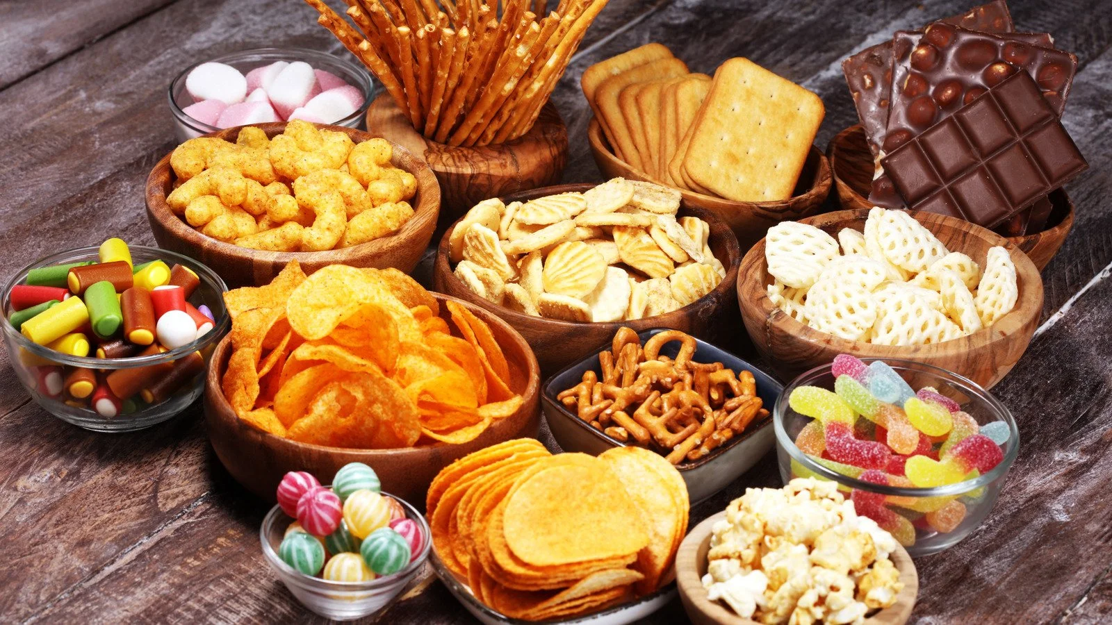 Slices of layered carrot cake with cream cheese frosting on a white plate