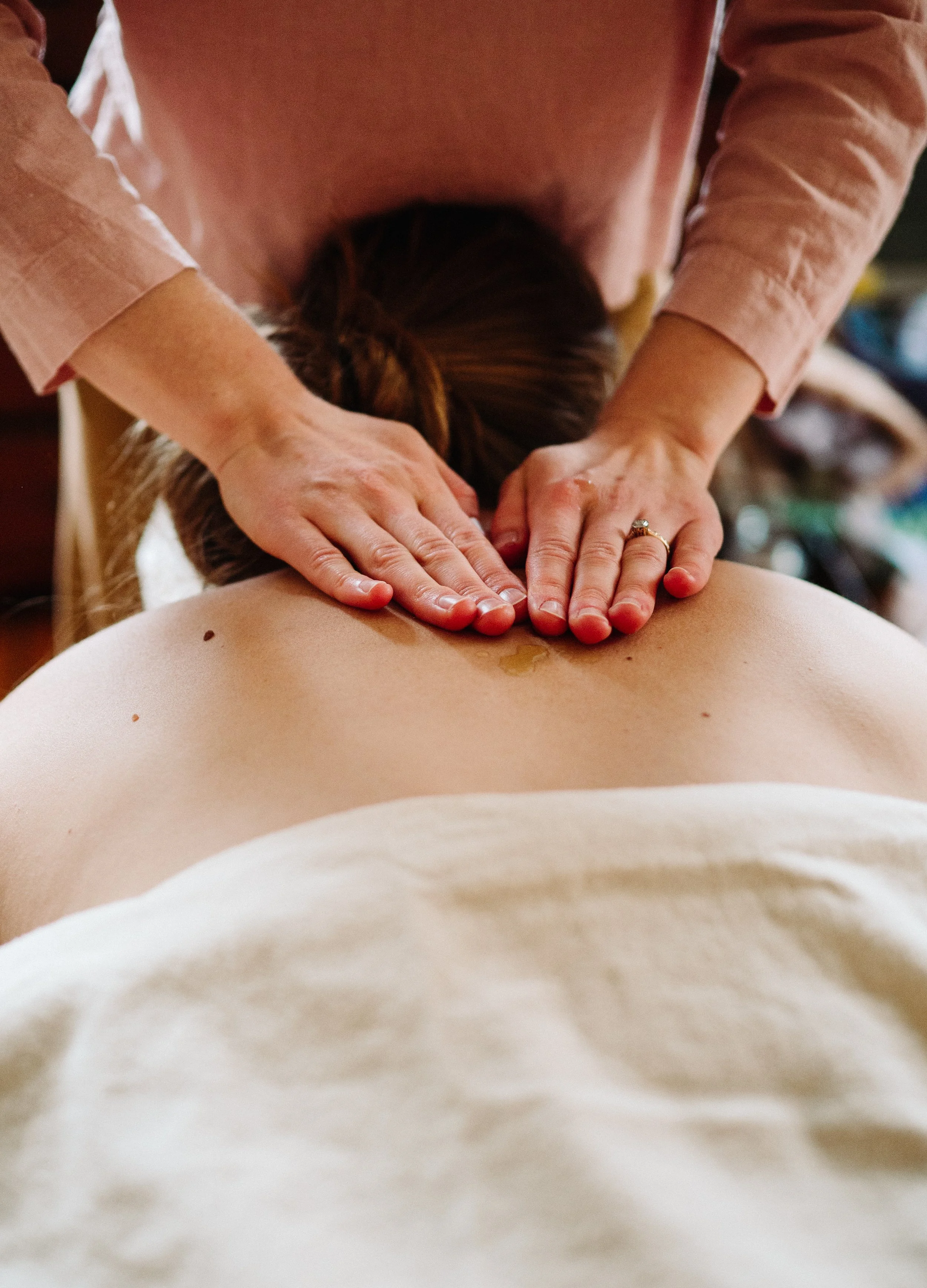 Practitioner performing postpartum bodywork treatment in Groton, Massachusetts