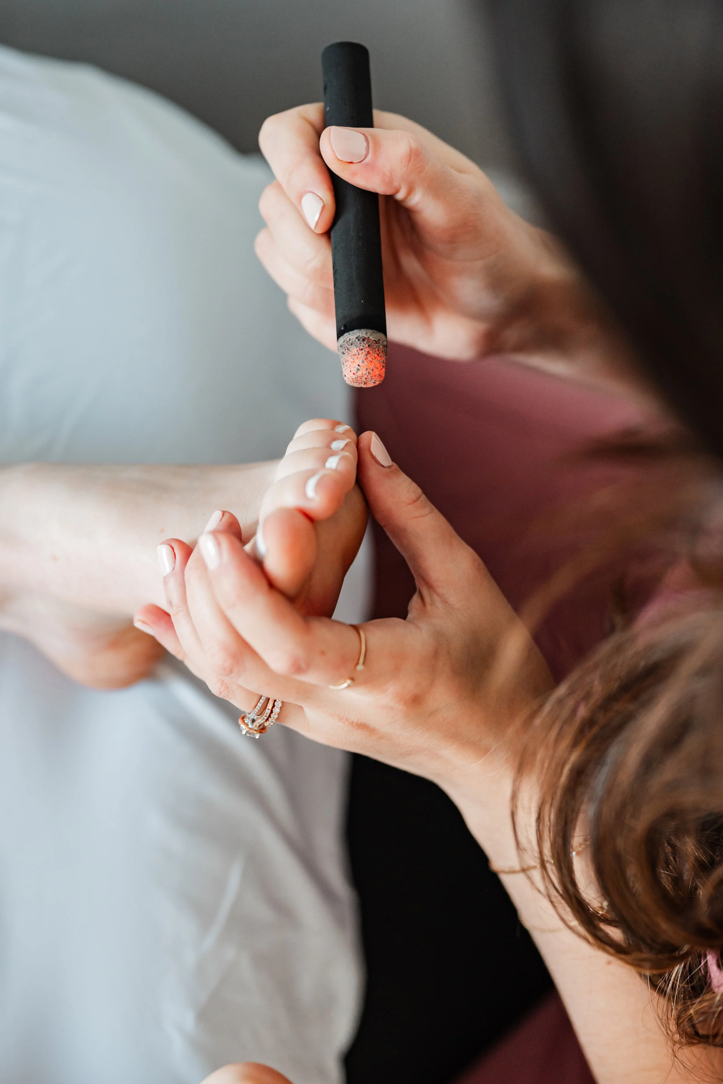 Close-up of moxibustion stick being used during acupuncture treatment at The Violette House in Groton, MA