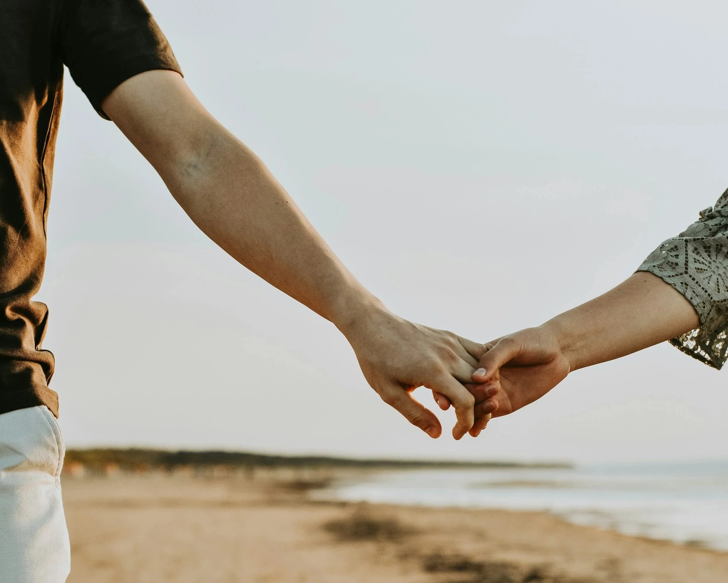 Couple holding hands supporting each other through male fertility journey Groton MA