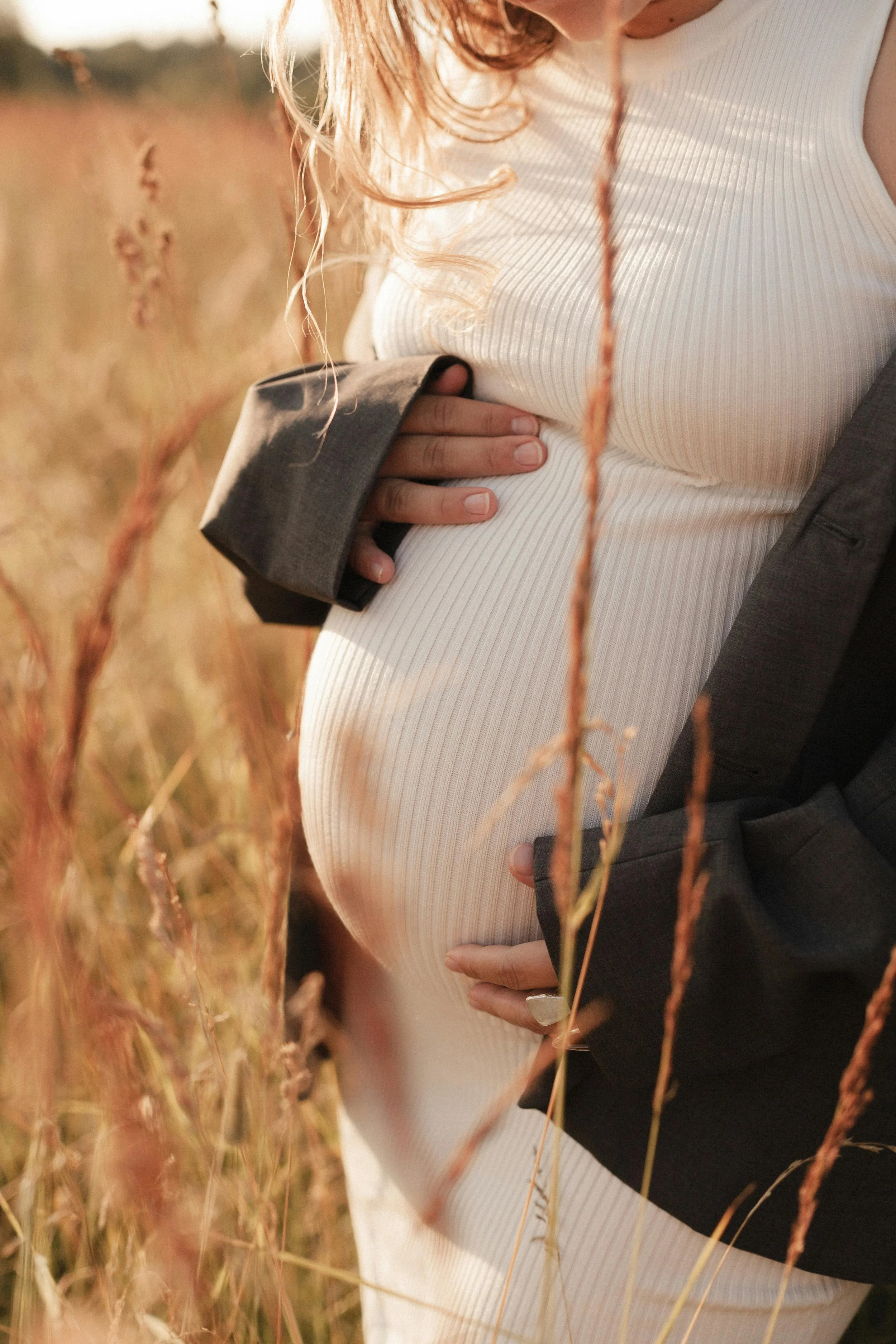 Pregnant woman resting comfortably on her side, experiencing relief from nausea through acupuncture care in Groton, MA