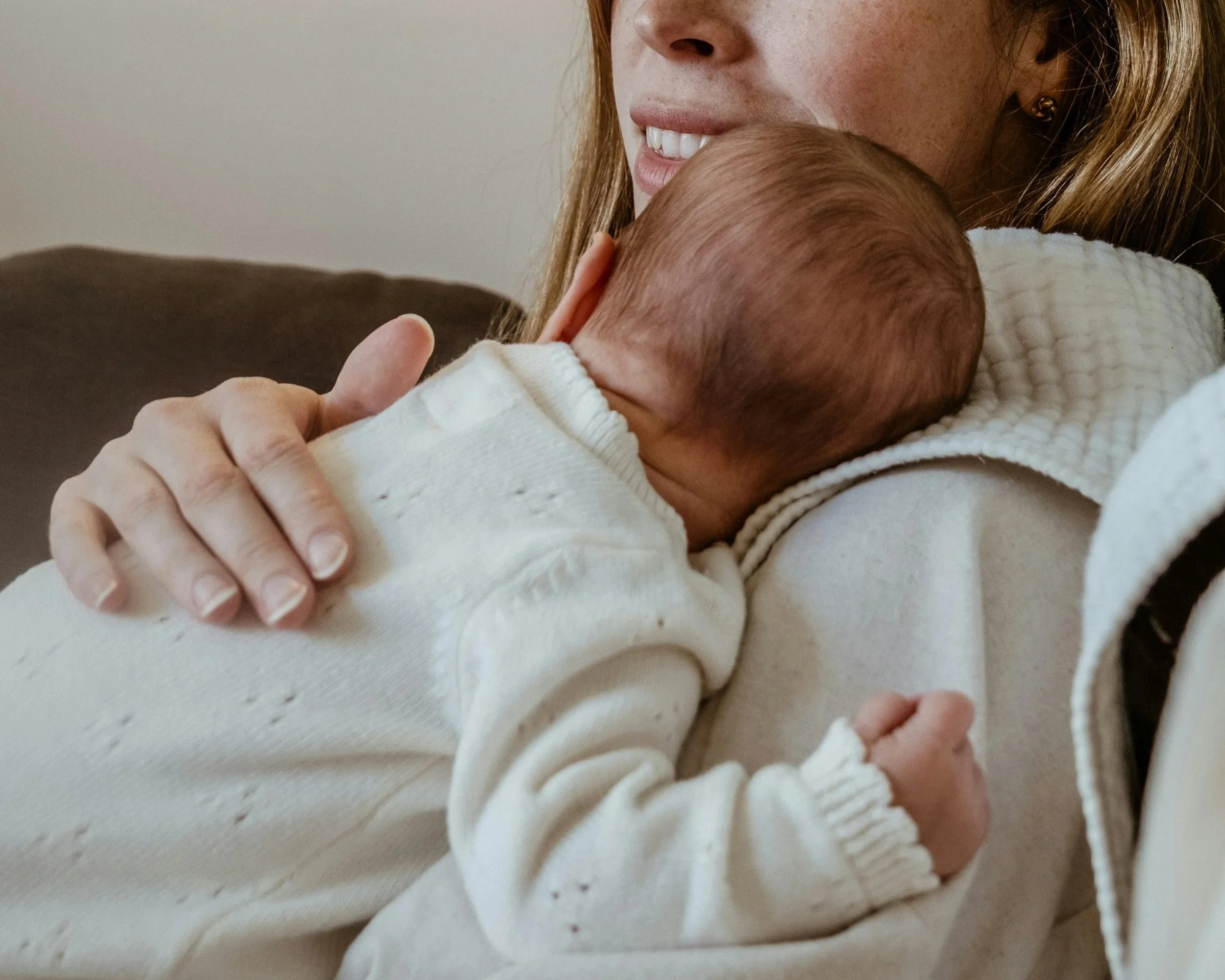 Mother holding newborn baby, representing the hope and outcome of natural fertility support at The Violette House in Groton, MA