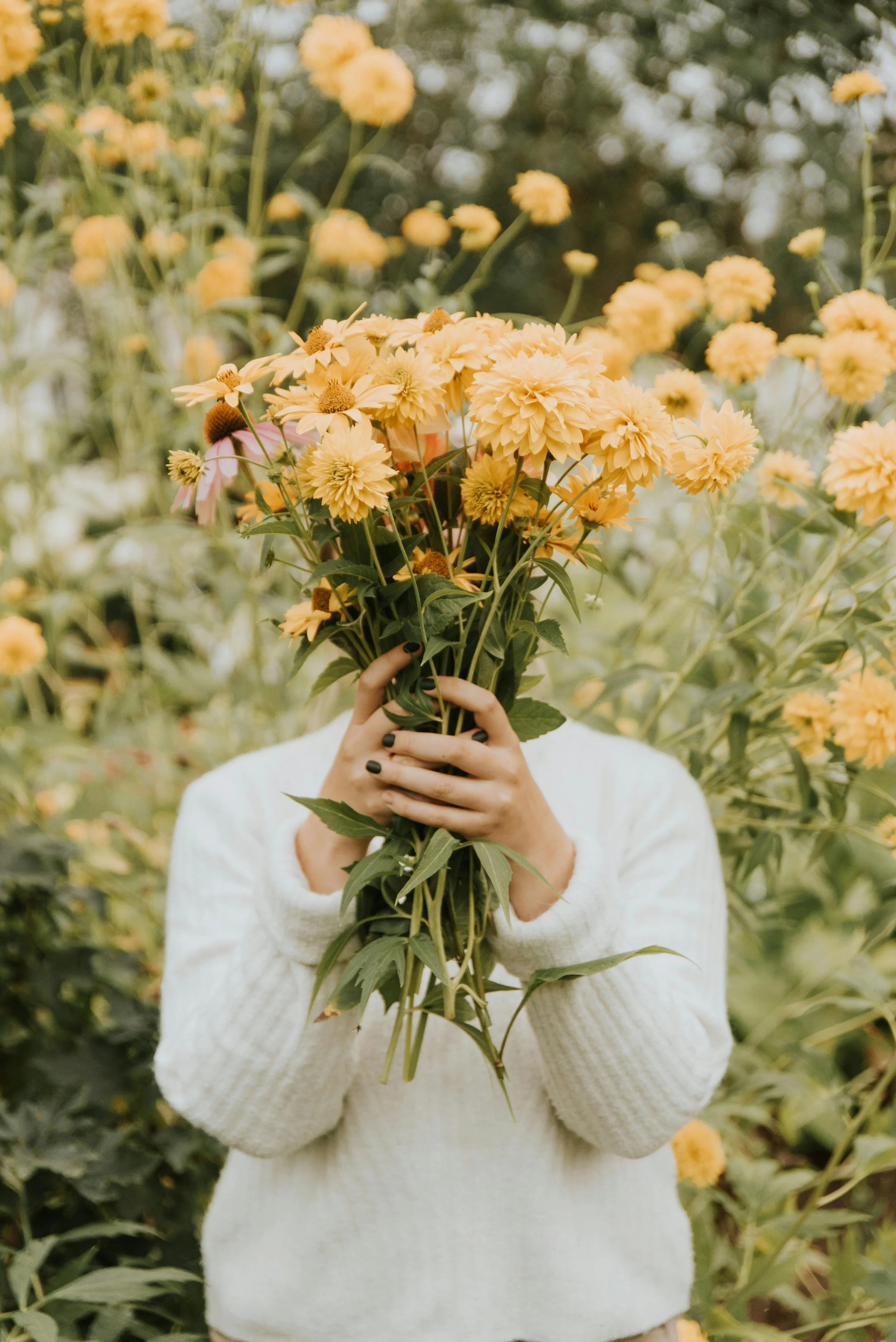 Woman outdoors holding flowers representing emotional wellness supported by acupuncture for anxiety in Groton, MA