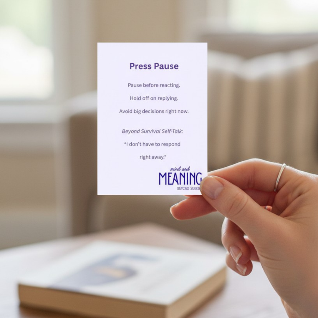Image of a hand holding a Beyond Survival coping card. The name of the card show is Press Pause.