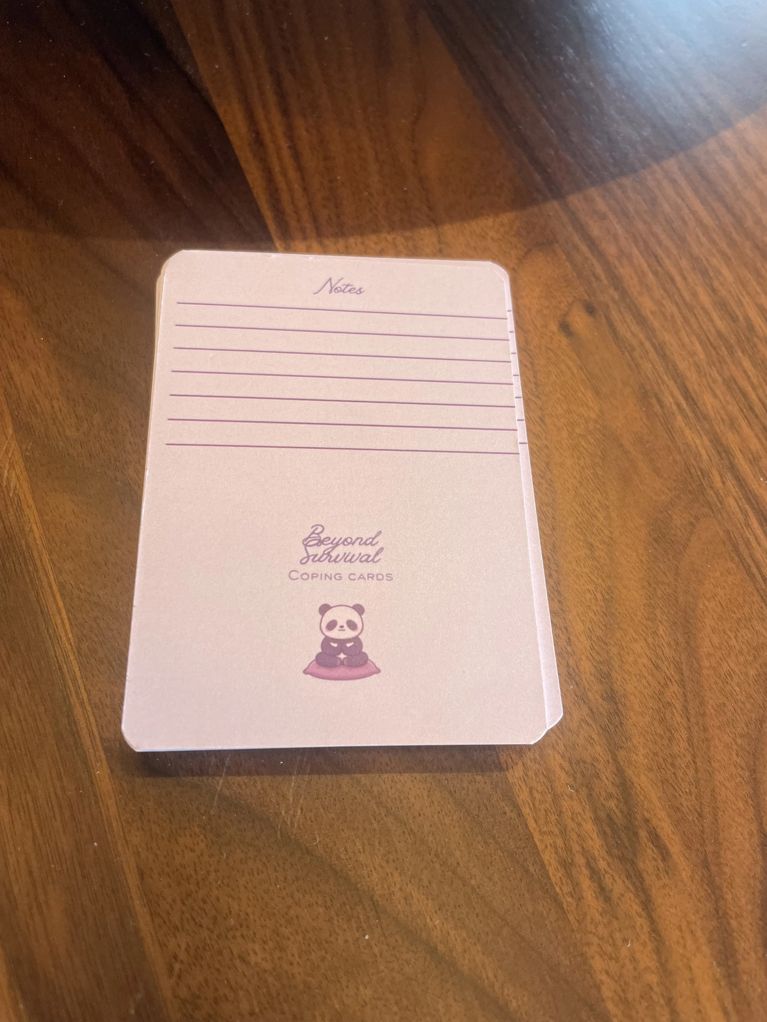 Back side of Beyond Survival Coping Cards. It features Paws the Panda and a lined note section.