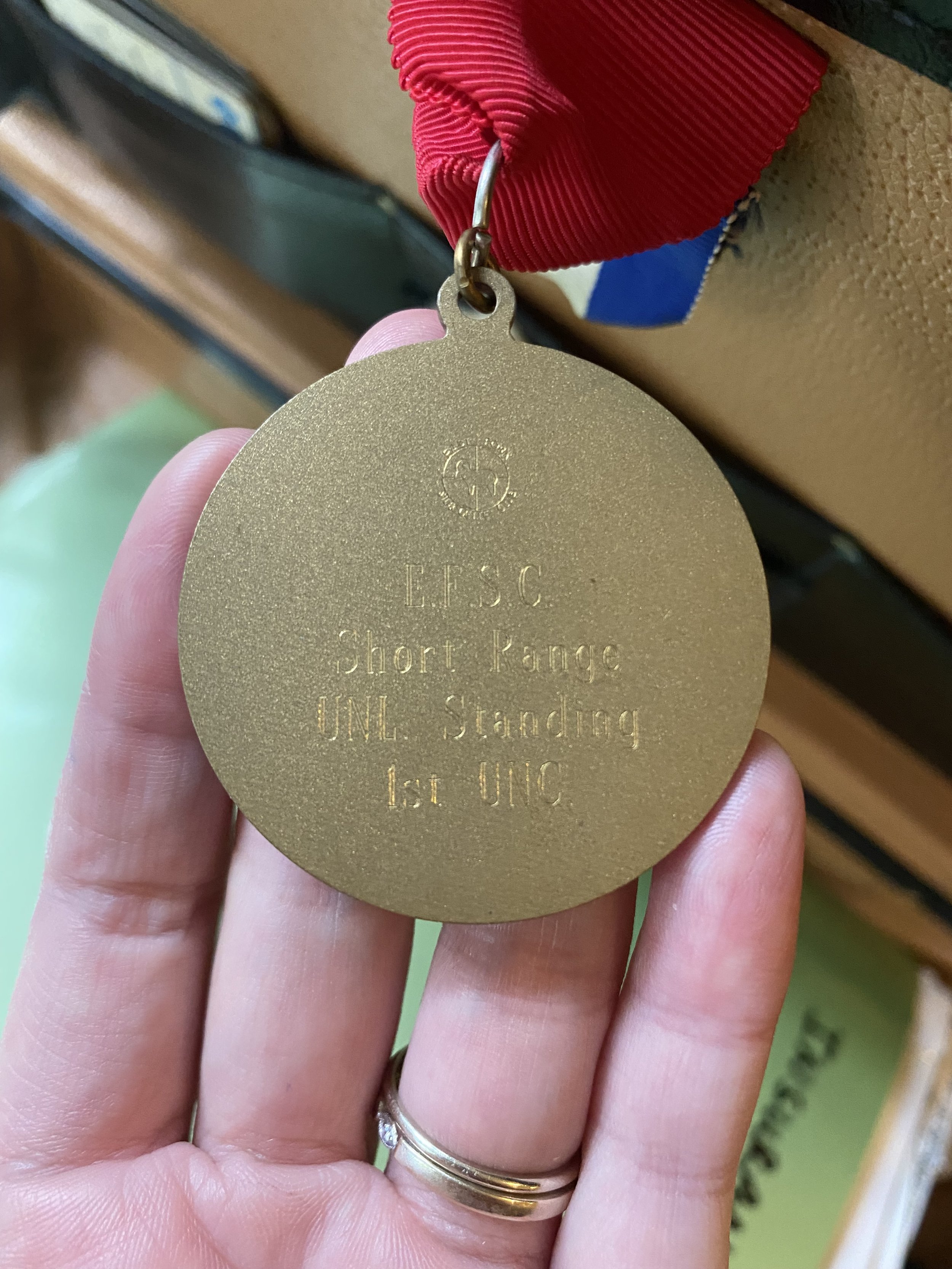 Back of medal, reads: "E.F.S.C., Short Range, UNL Standing, 1st UNC"