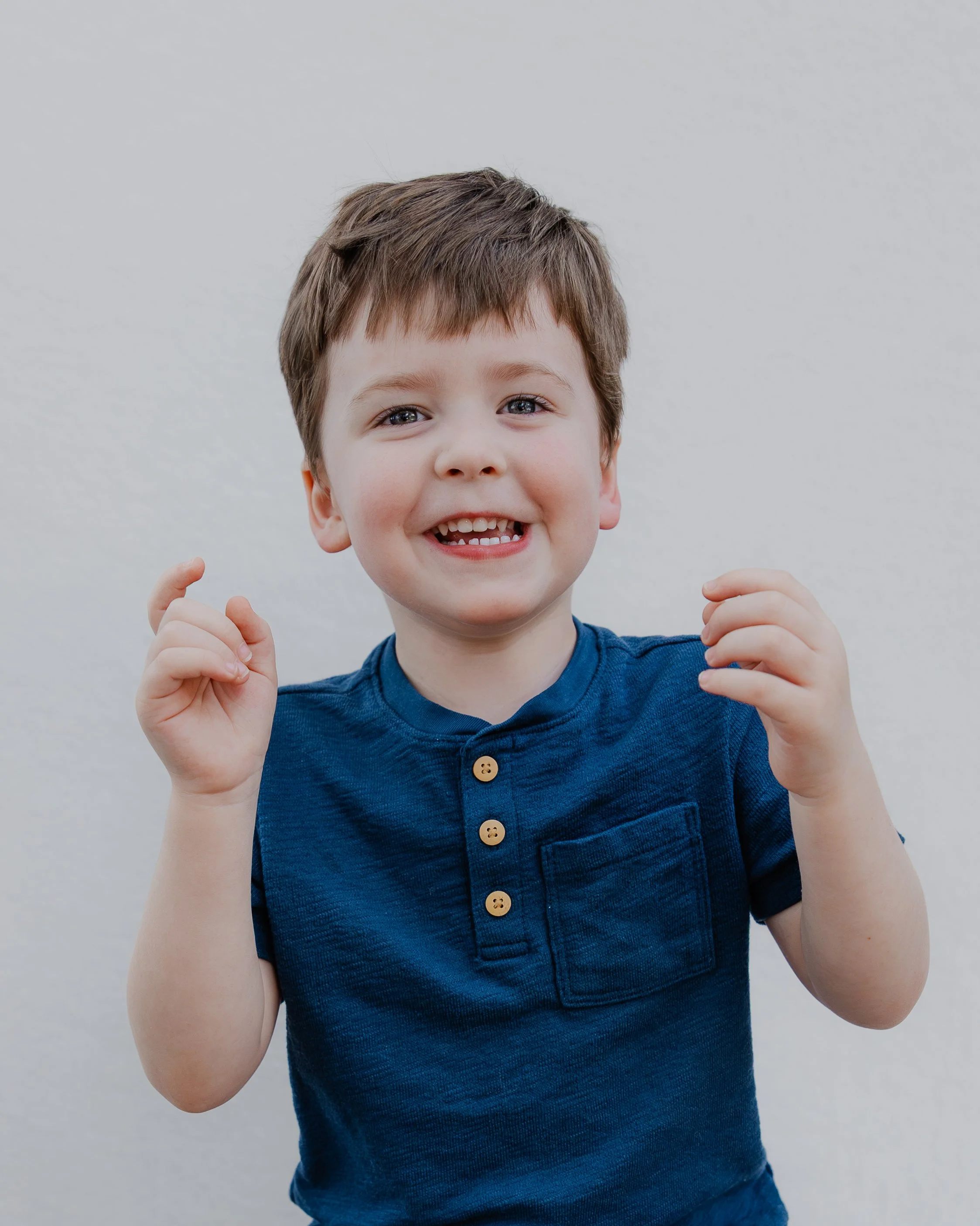 Young boy smiling during a children's mini photography session.