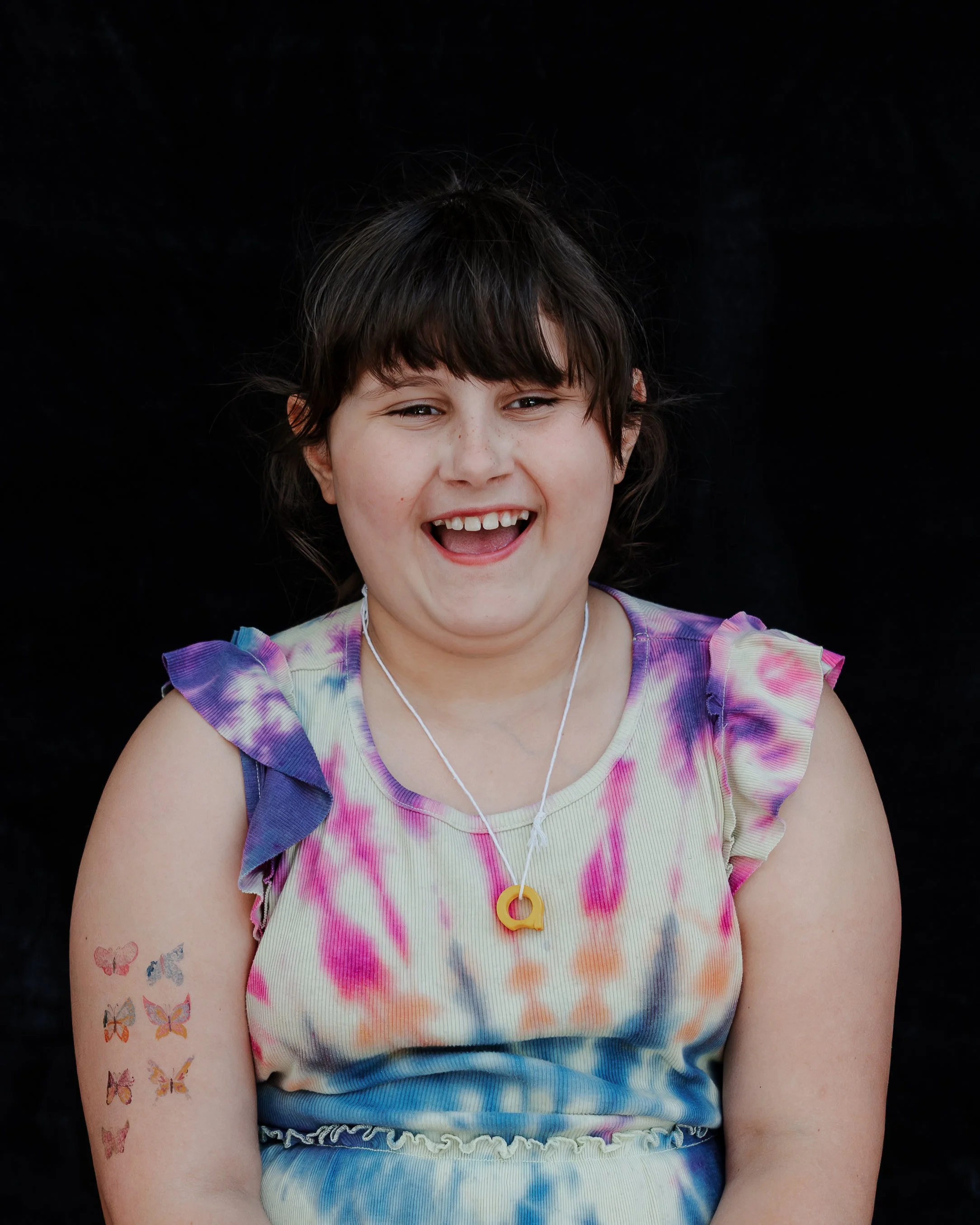 Young girl laughing during a studio mini session in Durham, NC.