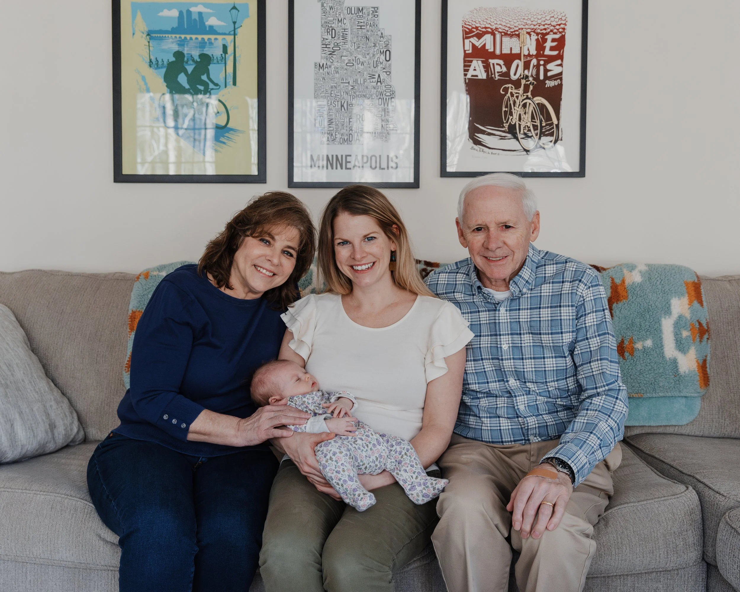 Grandparents join photos with newborn grandchild during a photo session at home in Raleigh, NC.