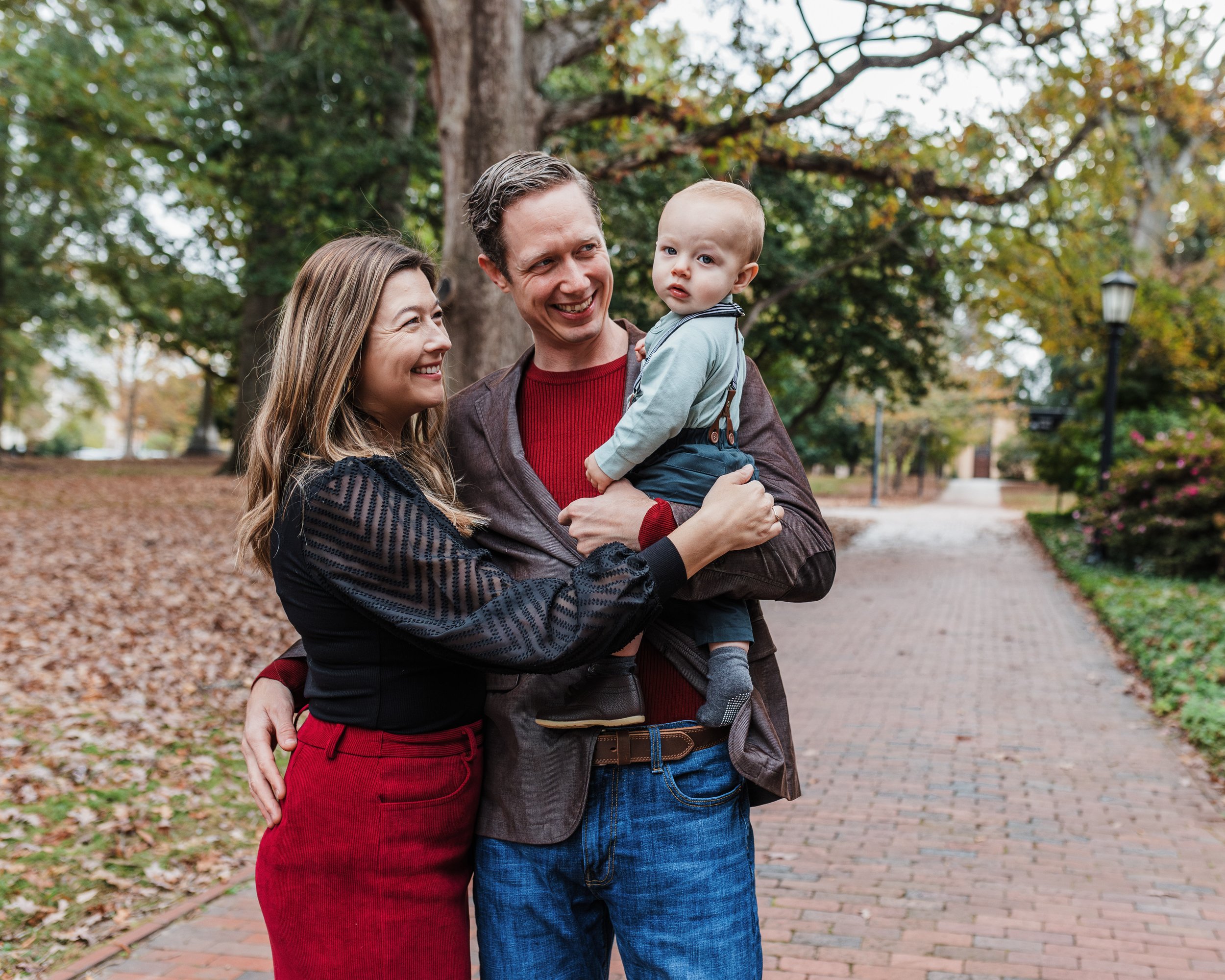 Couple pose with baby during professional family photos at UNC in Chapel Hill, NC.