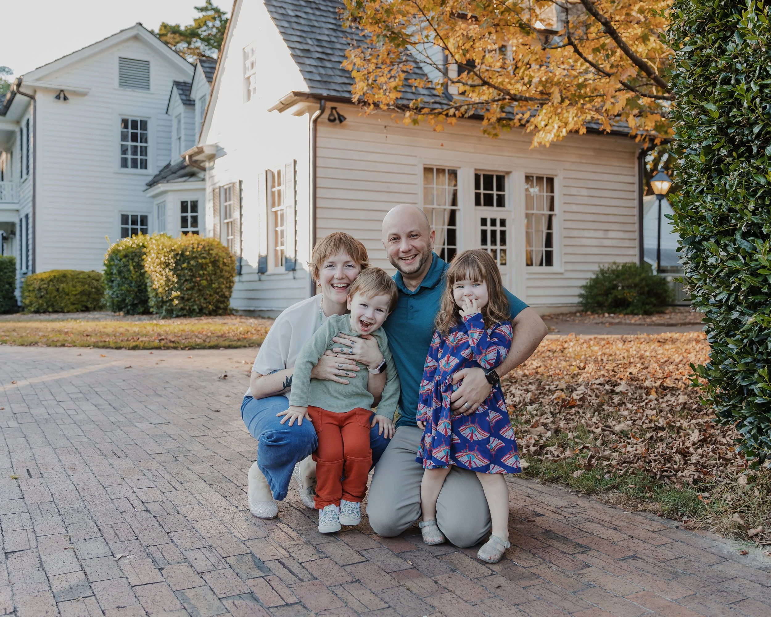 Parents pose with twin 2-year-olds during a fall family photo session at Historic Oak View County Park in Raleigh, NC.