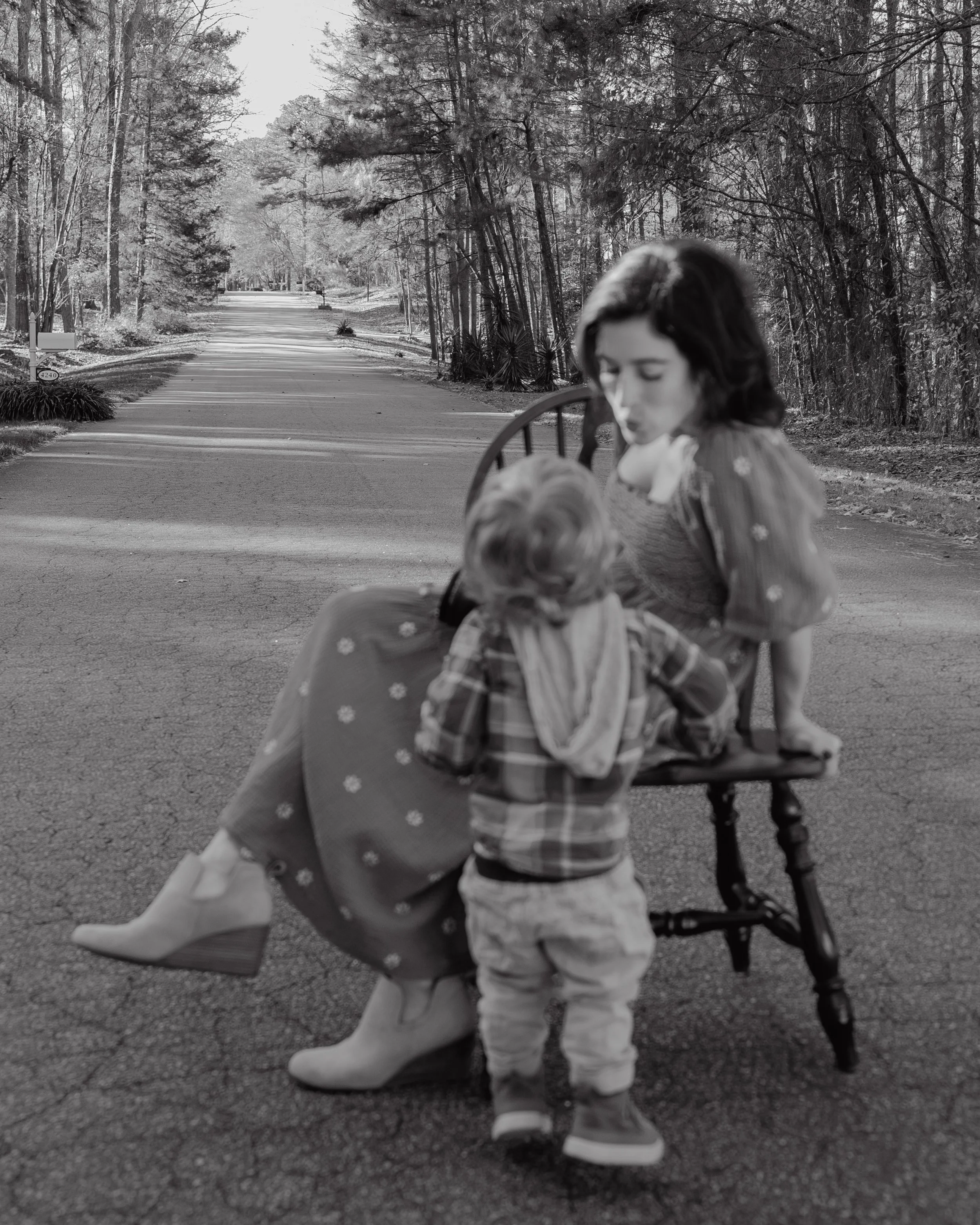 Family photographer's 2-year-old son interrupts branding photos for a kiss in Raleigh, NC.