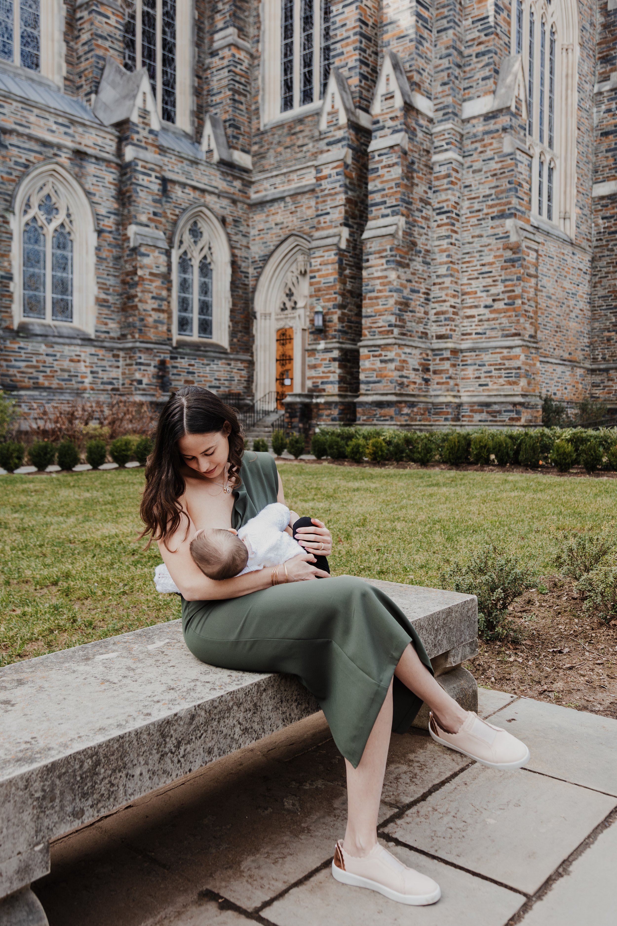 Mom breastfeeds baby next to the chapel at Duke University in Durham, NC.