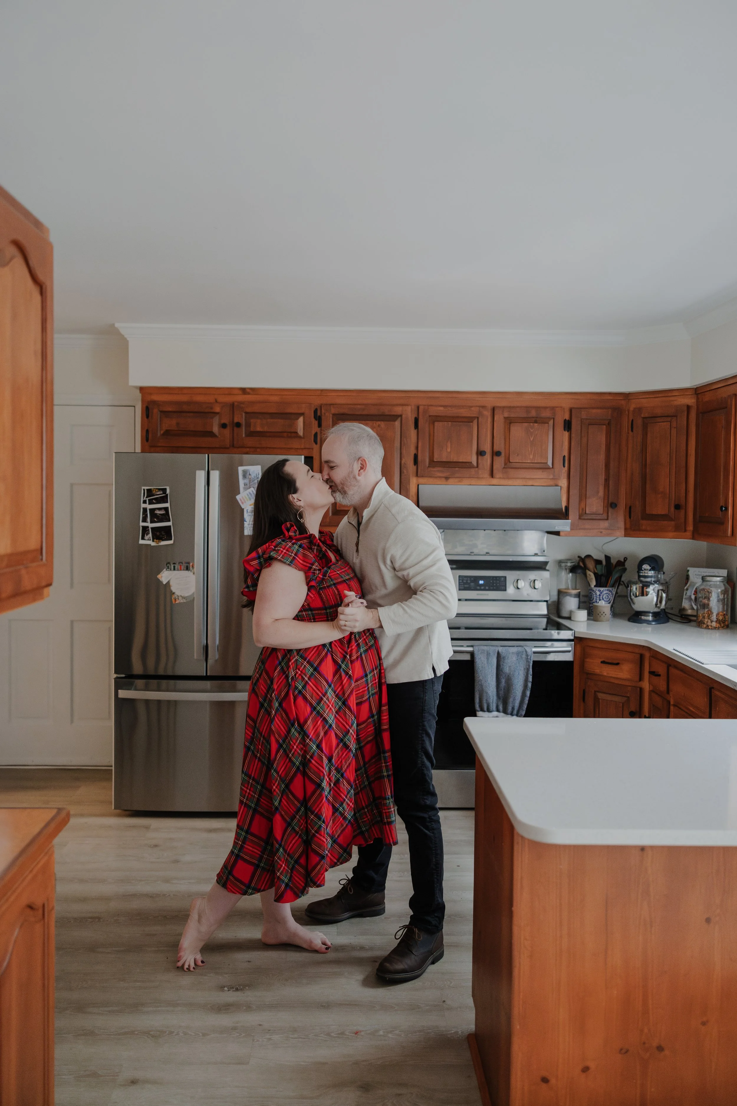 Mom and dad dance in the kitchen during a maternity photoshoot at their home in the Hope Valley area of Durham.