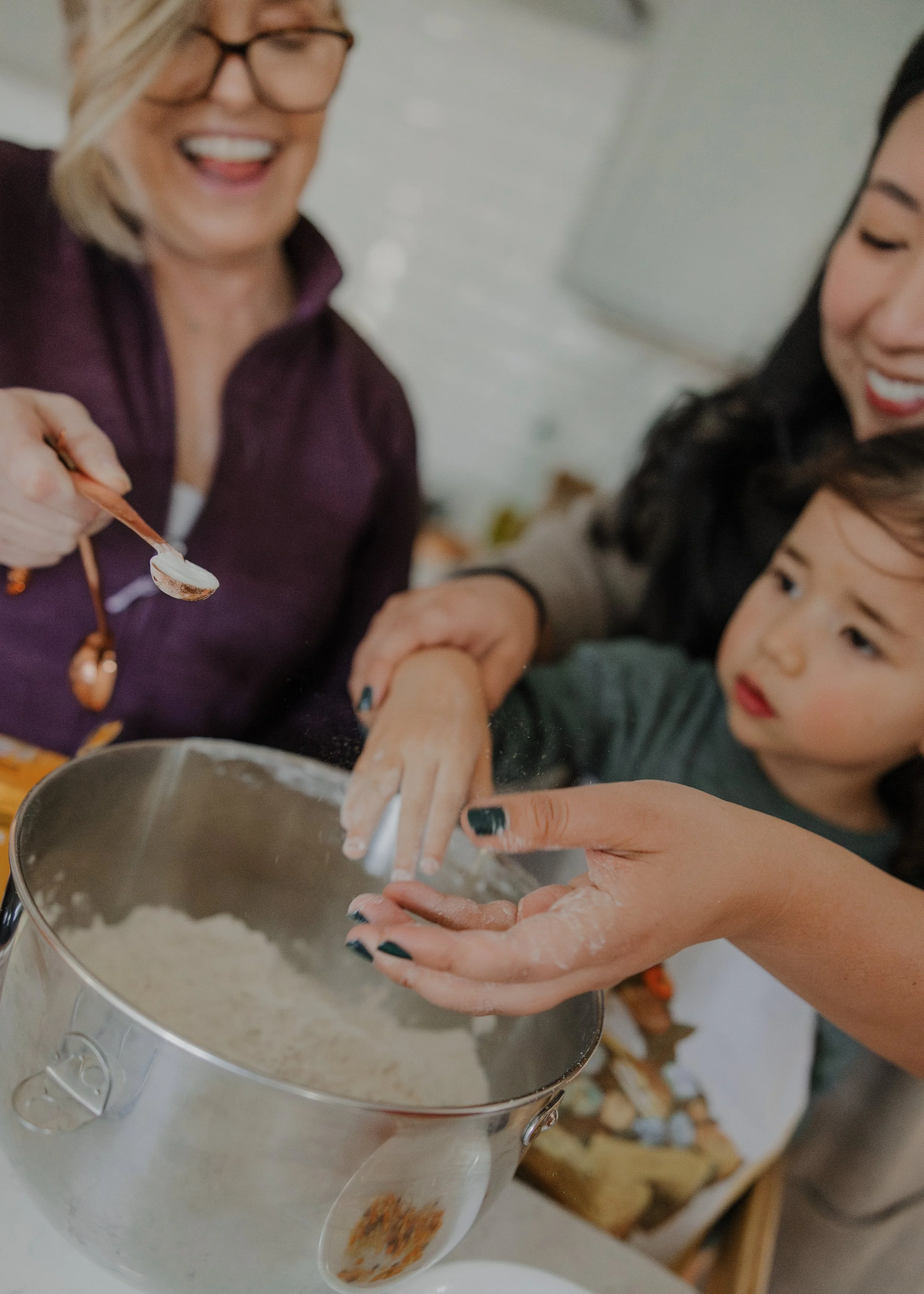 Multi-generational family baking together during a Chapel Hill extended family photo session.