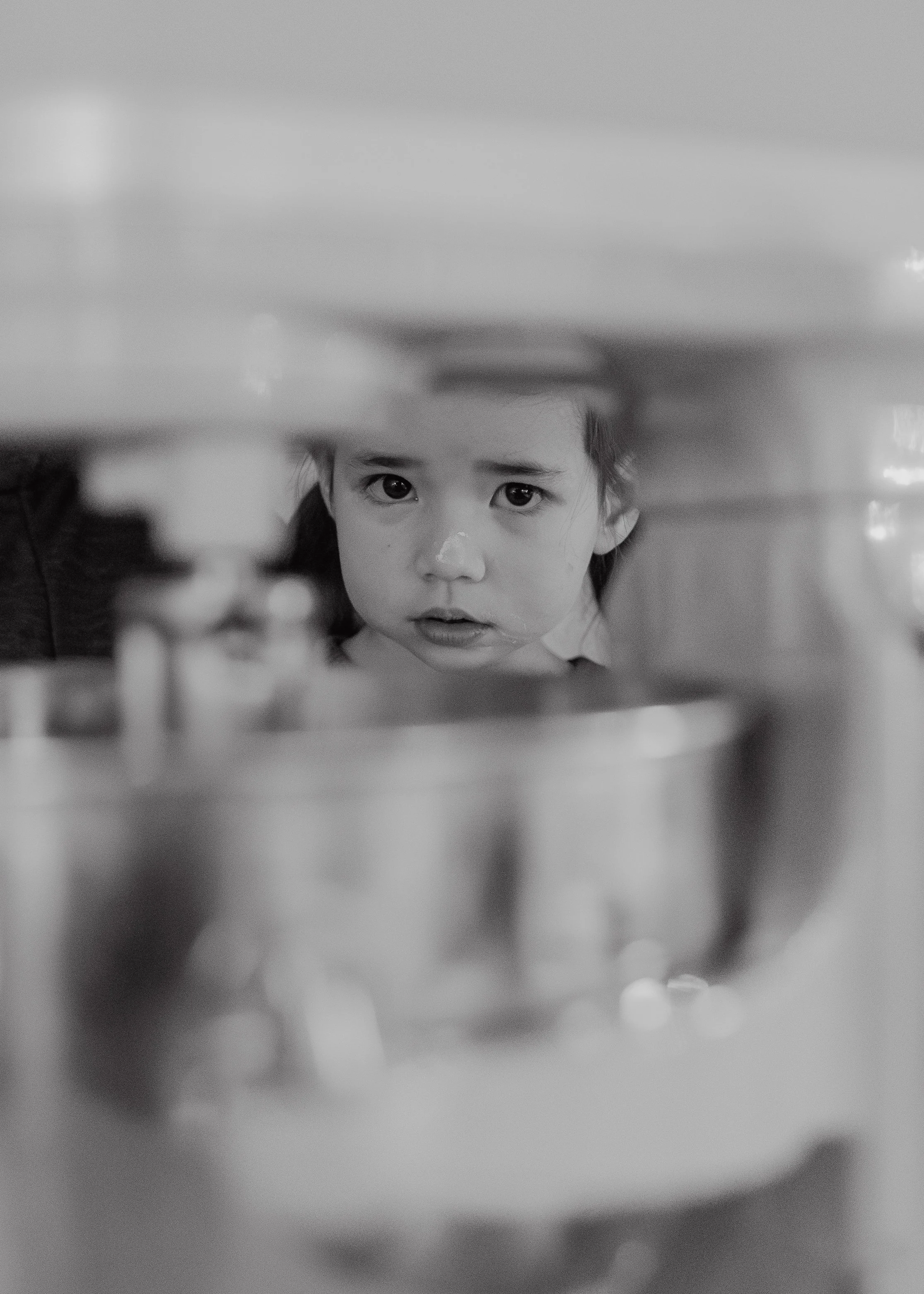 Toddler peeking through a stand mixer during an at-home family photo session in Chapel Hill.