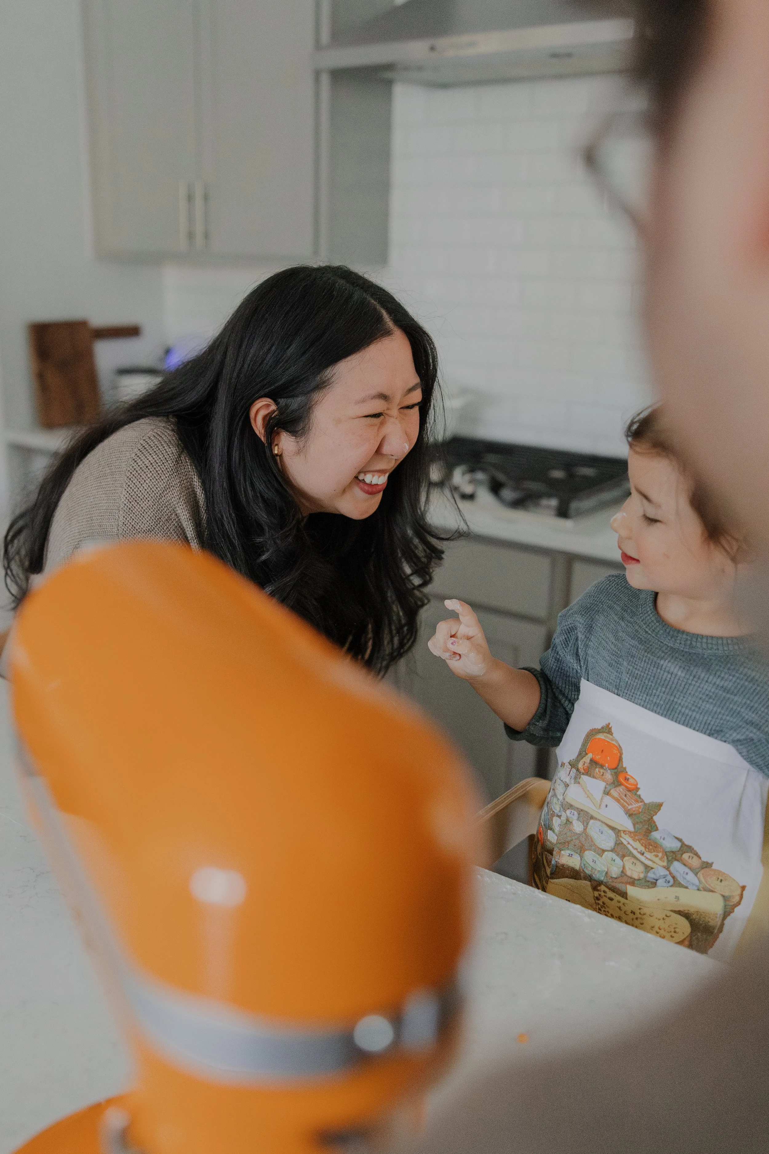 At-home family photography session in Chapel Hill capturing a mother and child baking together.