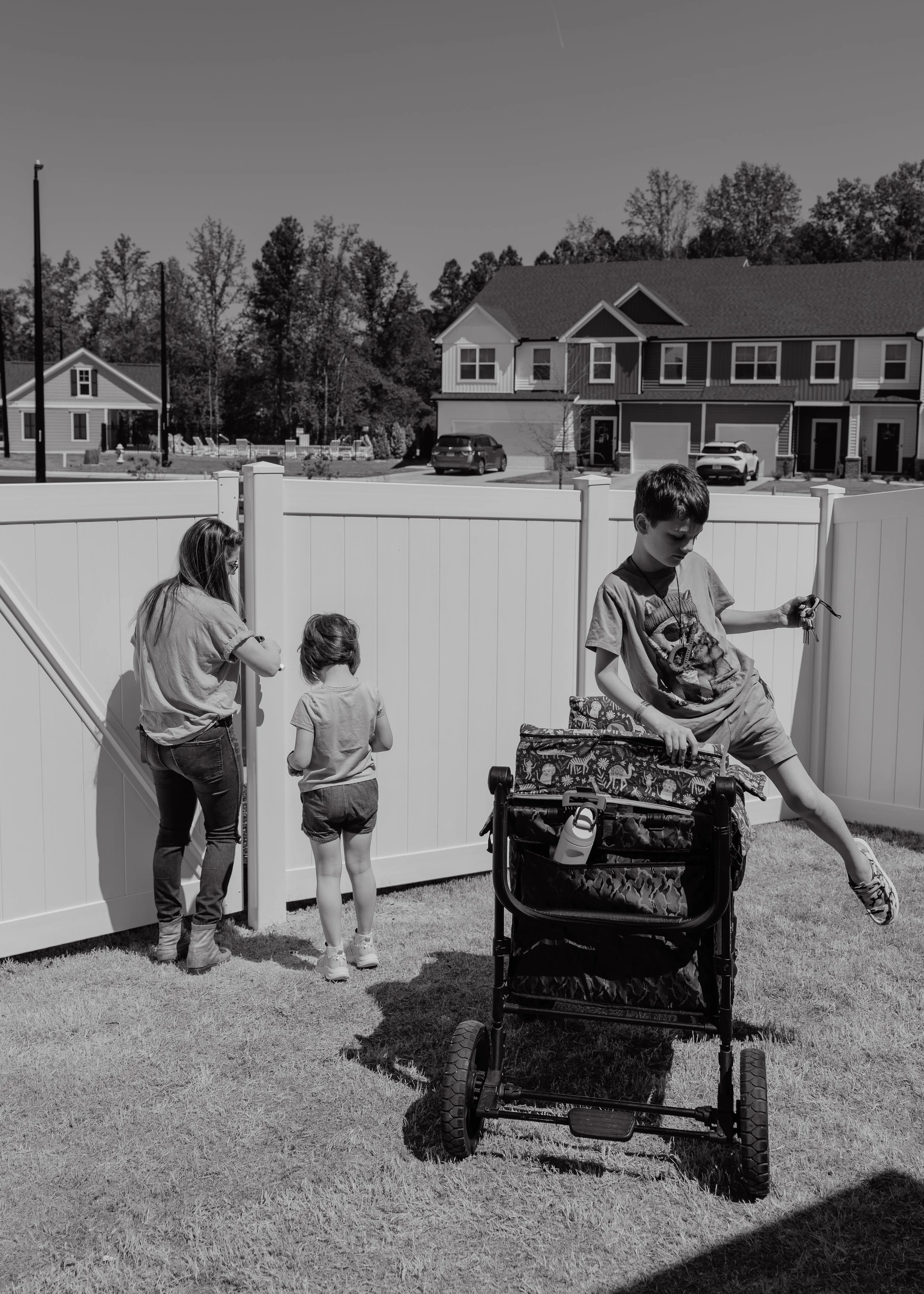 A mother and her two profoundly autistic children spend time together in their Wake Forest backyard before heading to a family photo session.