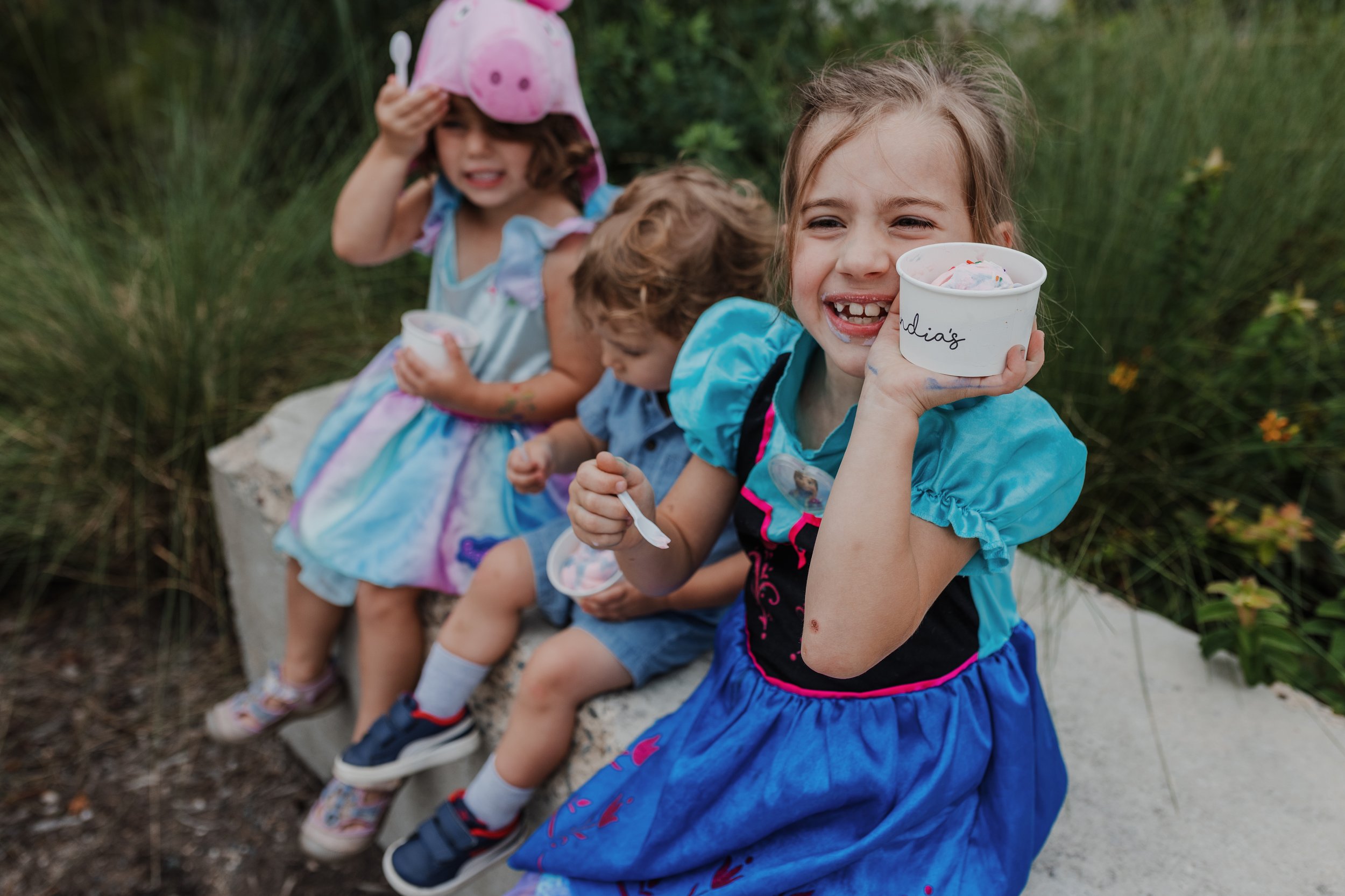 Three young children eating Andia's Homemade Ice Cream at Raleigh Iron Works