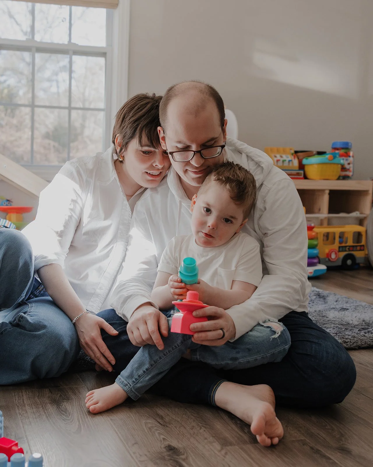 Quiet in-home family moment captured by an autism-friendly family photographer in Raleigh during an accessible photo session with a child on the autism spectrum.