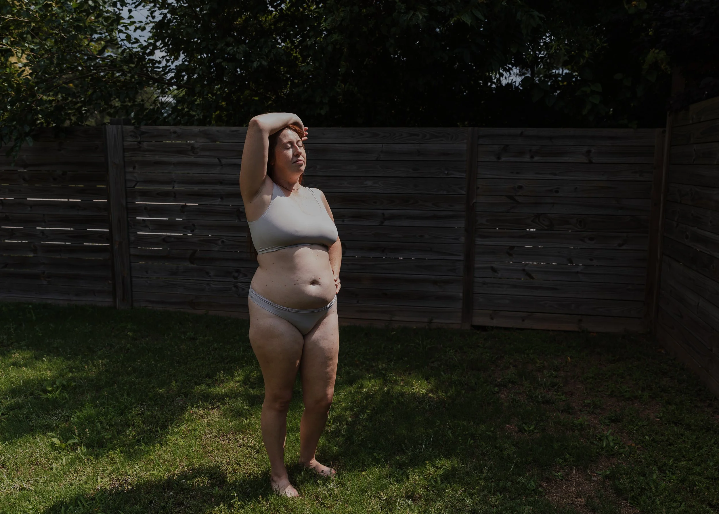 A new mother shows off the way her body has become more beautiful and strong since having a baby, captured during a professional motherhood photo session in Raleigh, NC.