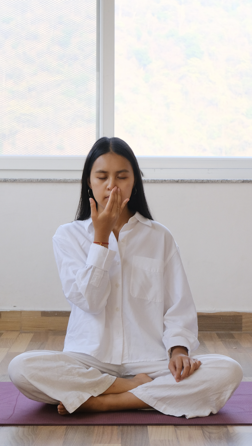 teacher practicing pranayama on yoga mat before meditation