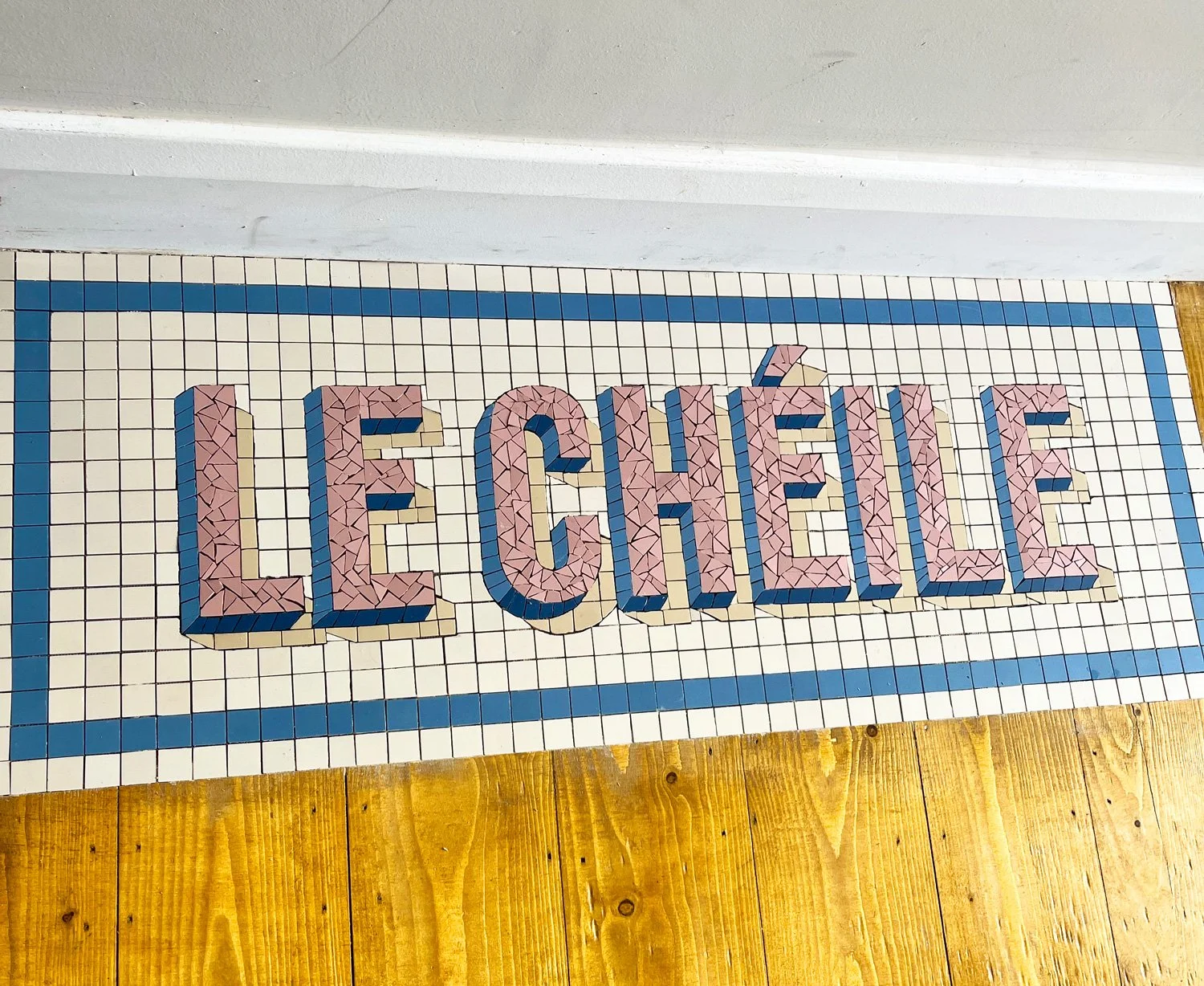 Le Chéile Mosaic in block lettering with blue border