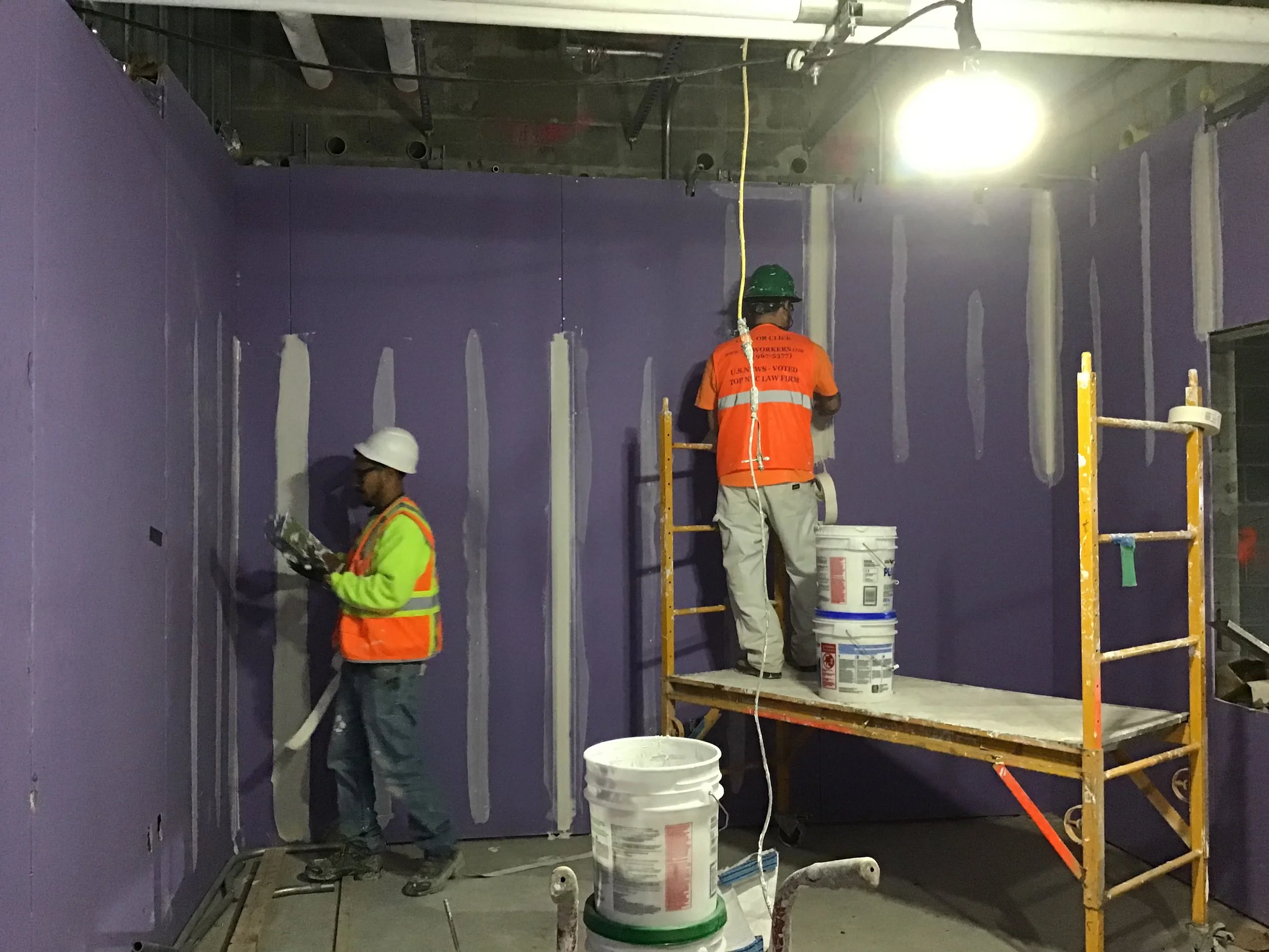 Taping_gypsum_board_seams_in_back_of_house_rooms_in_the_new_LIRR_passenger_concourse_in_preparation_for_painting_and_final_finishes._4-17-19_(47645209441).jpg