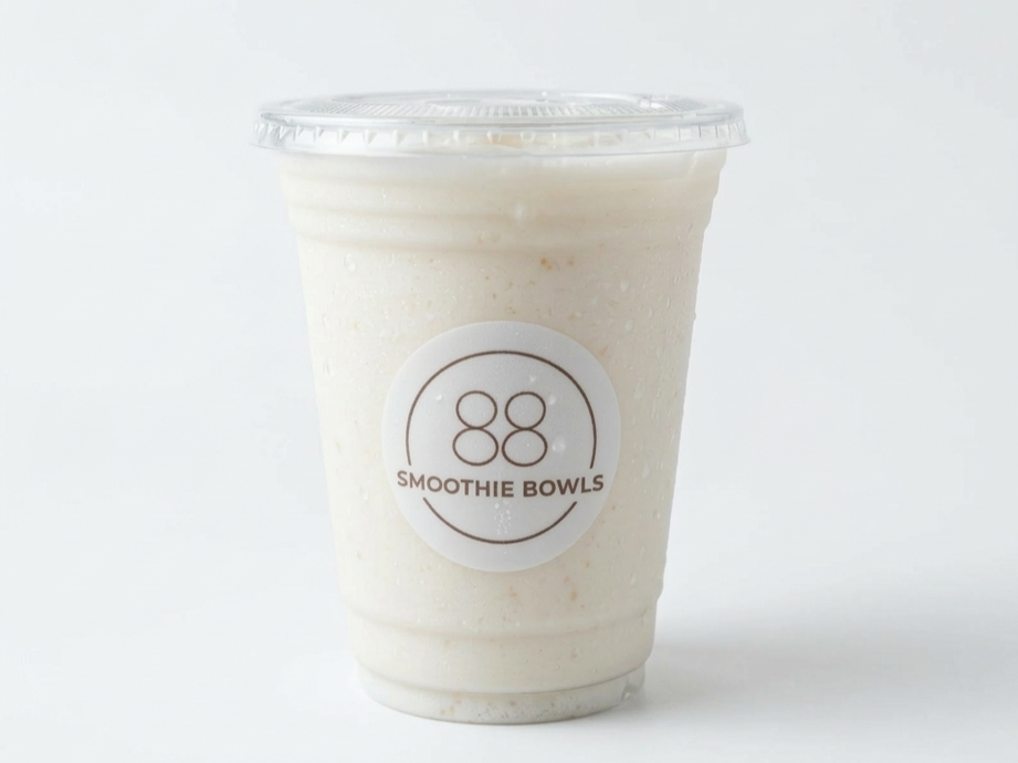 A smoothie in a clear plastic cup with a lid, featuring a logo that says '88 Smoothie Bowls' on the front.