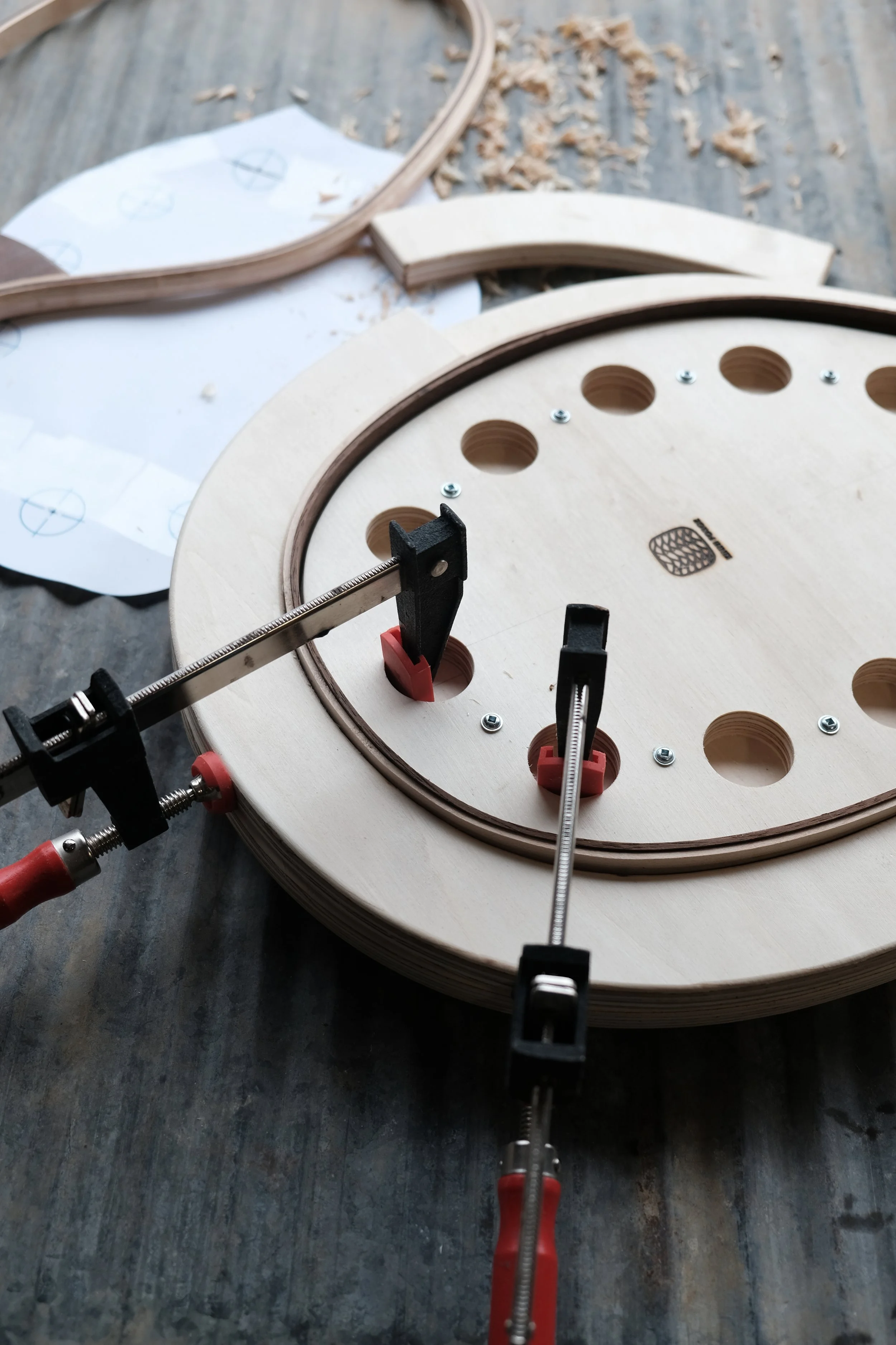 Clamping wood strips to a wood mold for hand crafted fishing net frames.