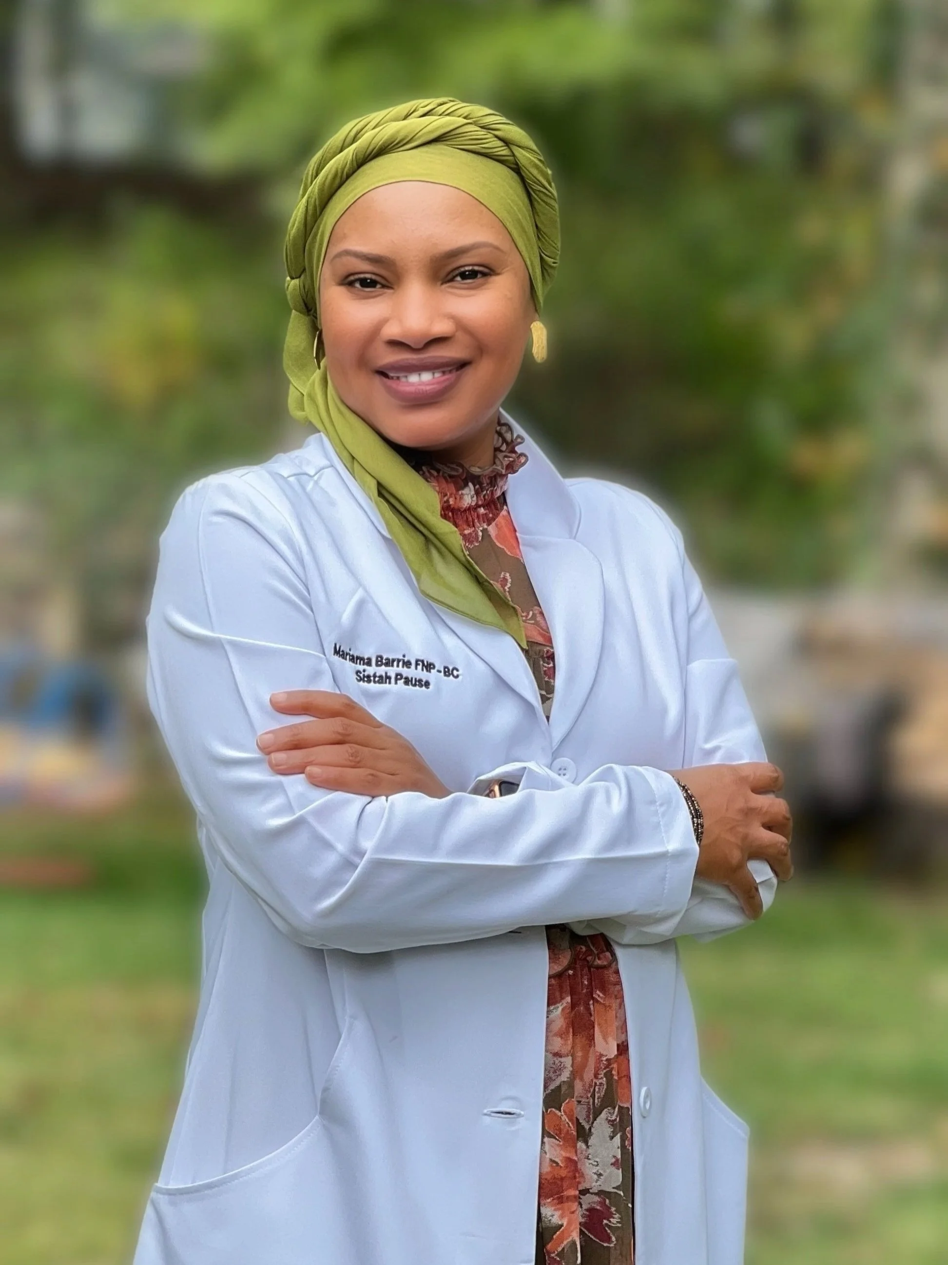 Mariama, a Black woman wearing a white coat, smiling warmly as your trusted provider.