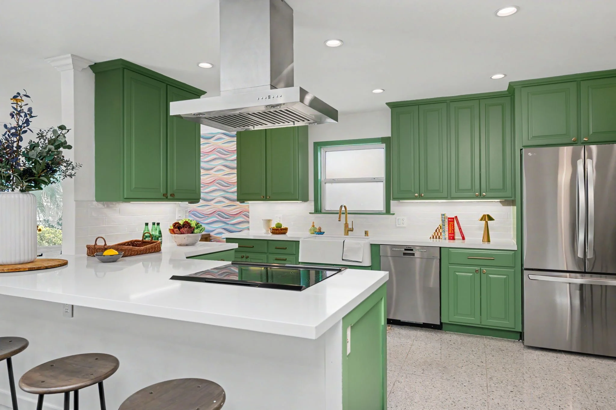 Spacious kitchen with poppy Kelly green cabinets and stark white countertops.
