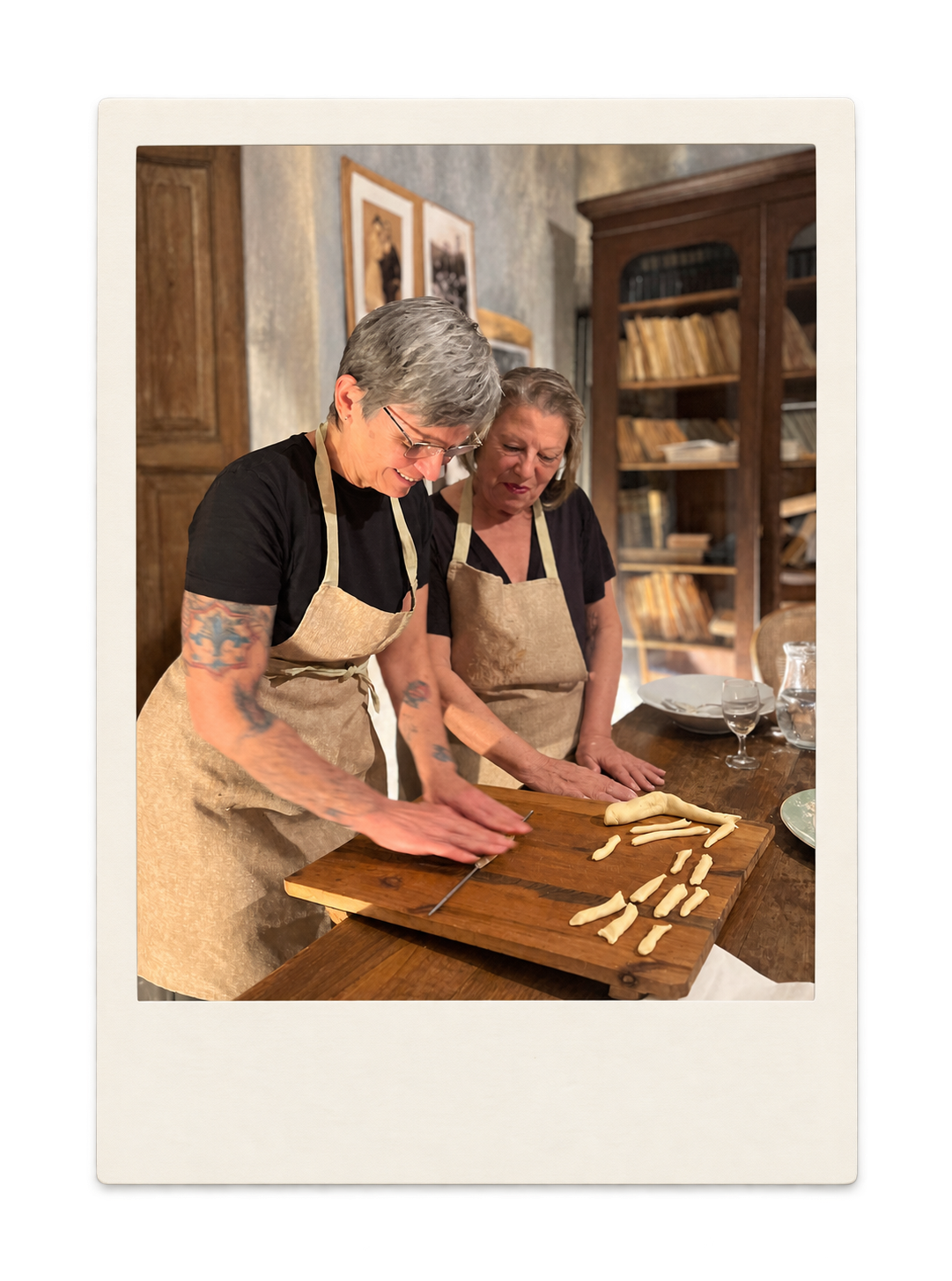 Two students learning to make pasta during a cooking class