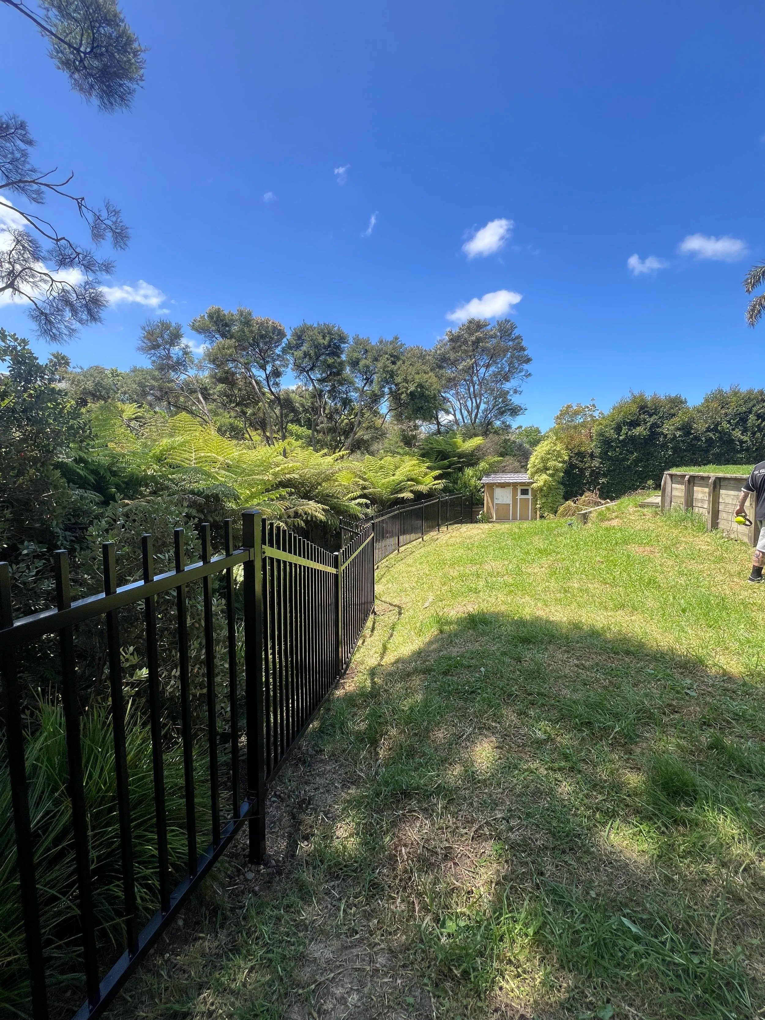 Black aluminium boundary fence on a sunny day, Auckland