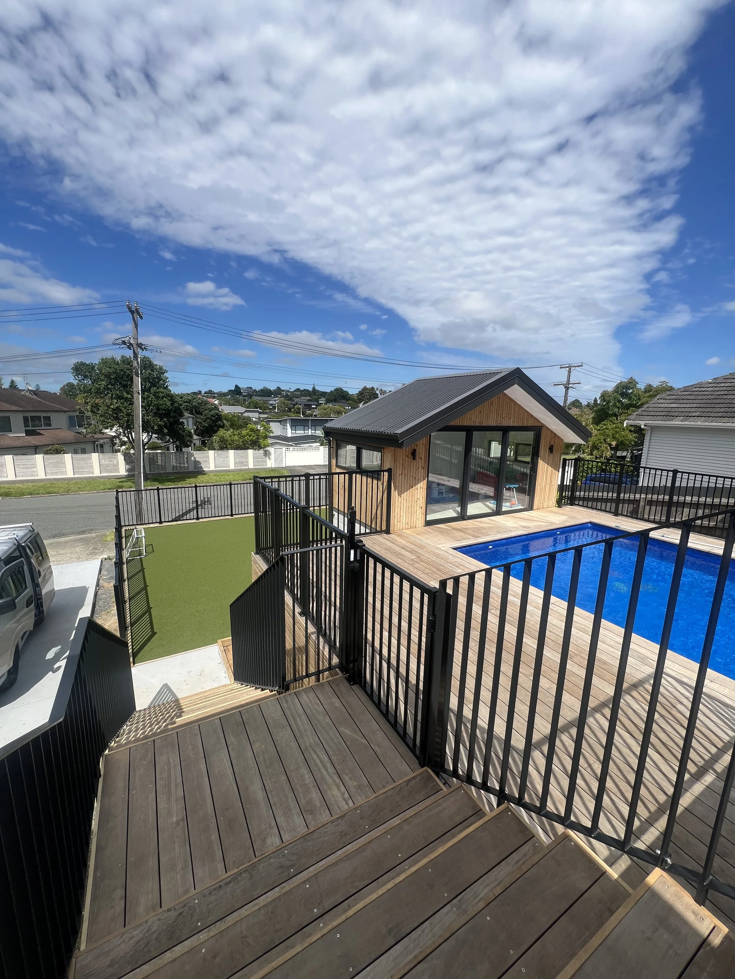 Black aluminium pool fence, gate and stairs on a deck, Auckland