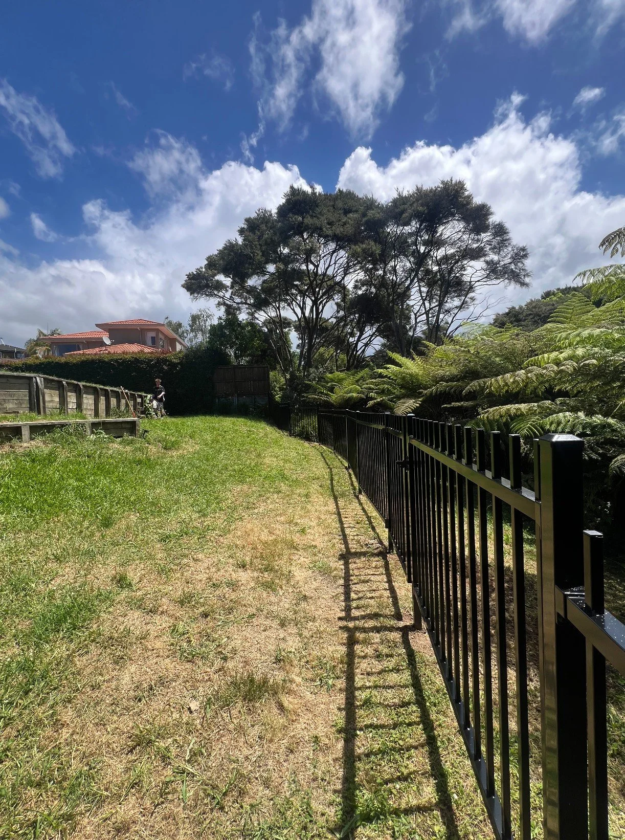Black aluminium boundary fence under blue sky, West Harbour, Auckland