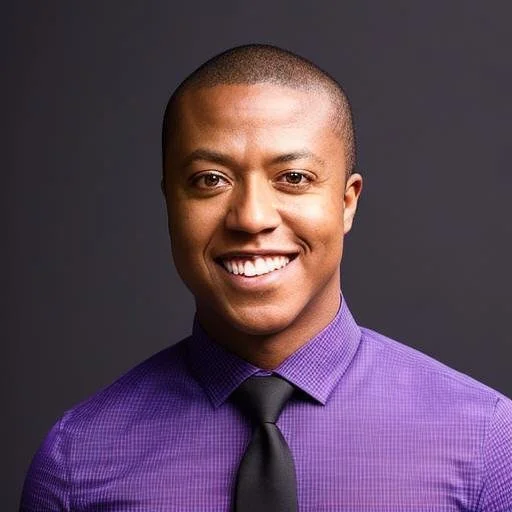 A smiling man with short hair, wearing a purple shirt and a black tie, against a dark background.