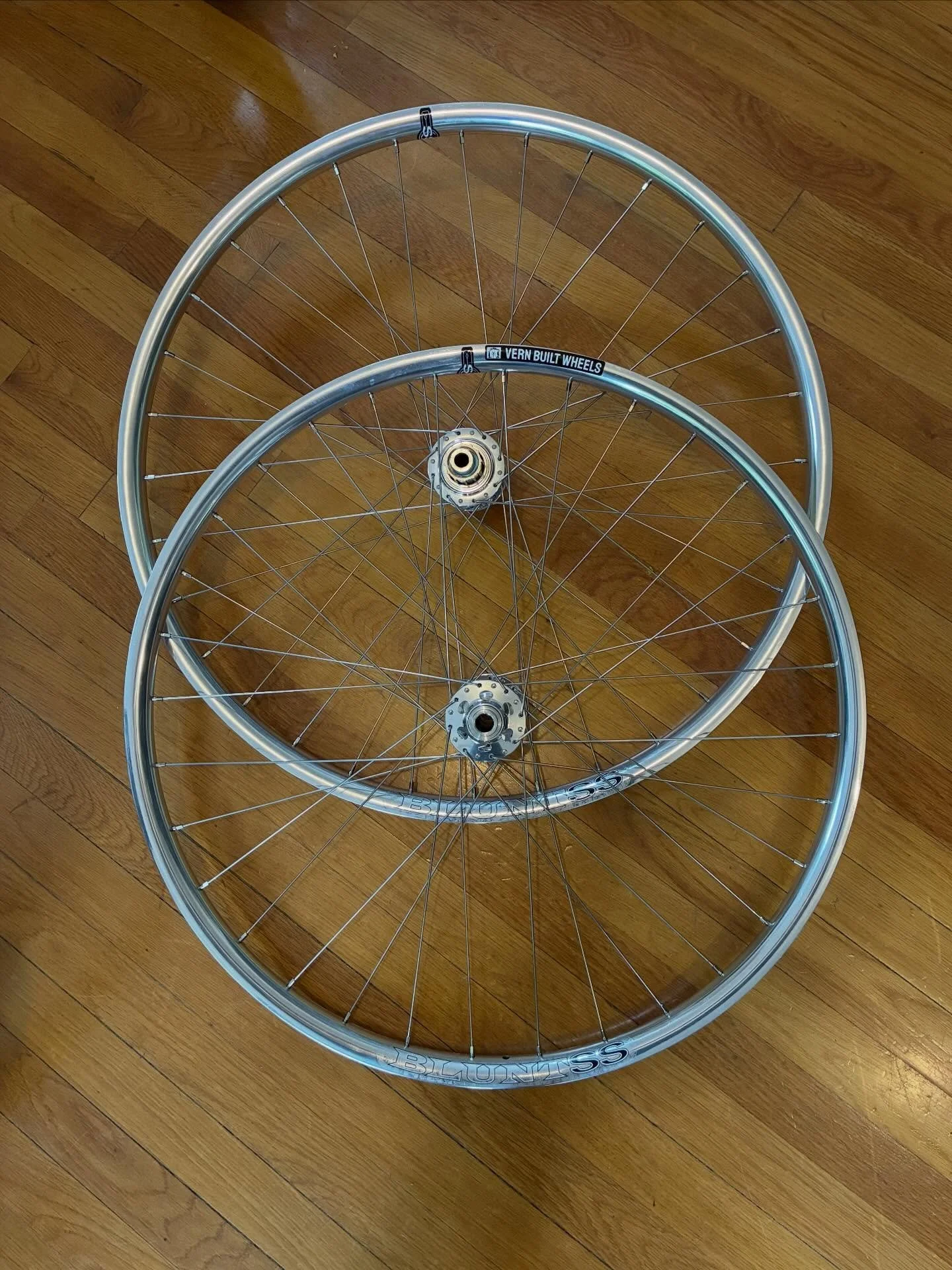 Don&rsquo;t be blinded by the light when these pass you on our local trails. Velocity Blunt SS polished rims laced to White Industries CLD hubs. I believe you could shave in the reflection of the rims. 1800 grams. #vernbuiltwheels #handbuiltwheelsare