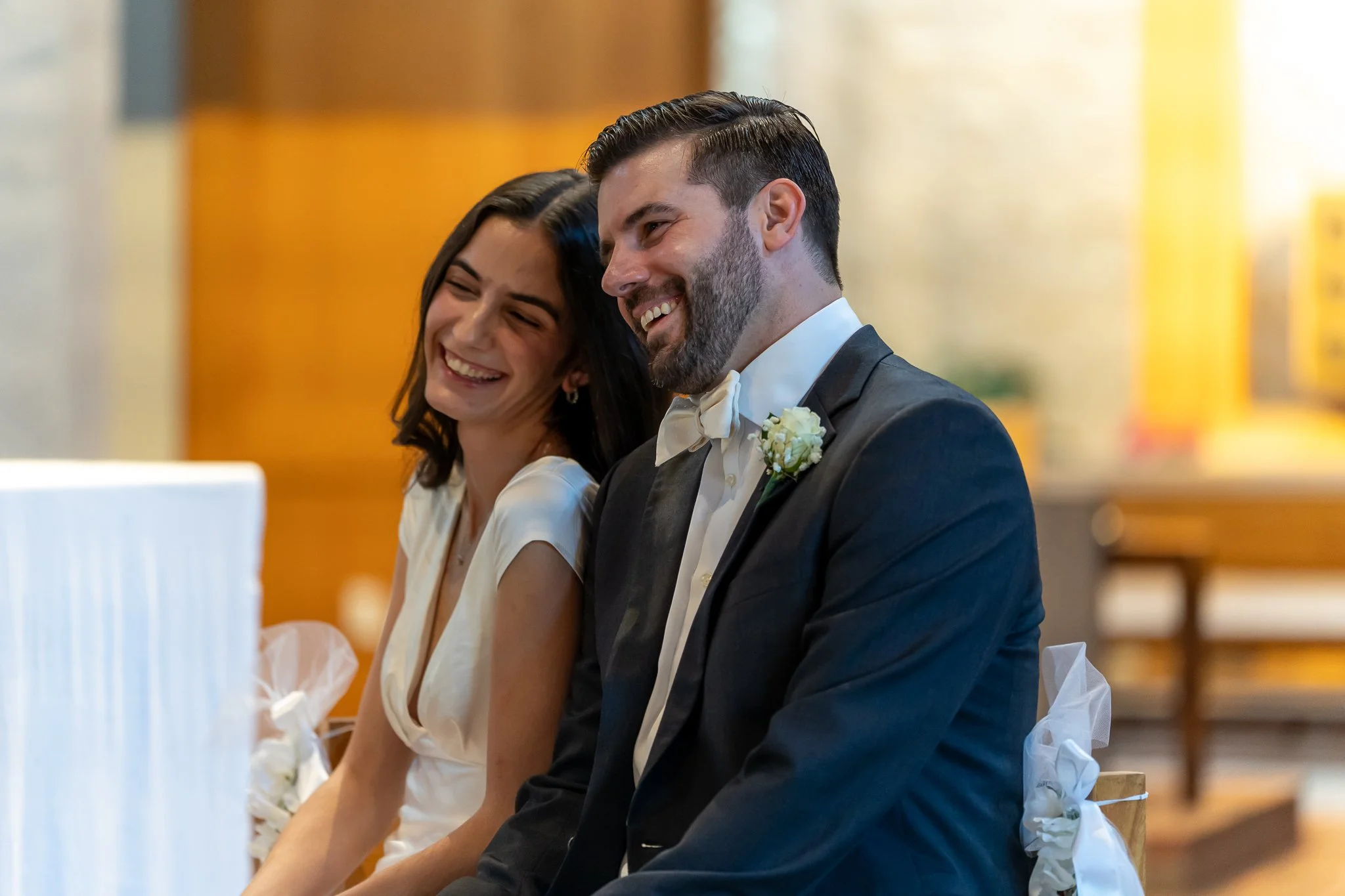 Bride and groom share a laugh at wedding ceremony in Raleigh, NC