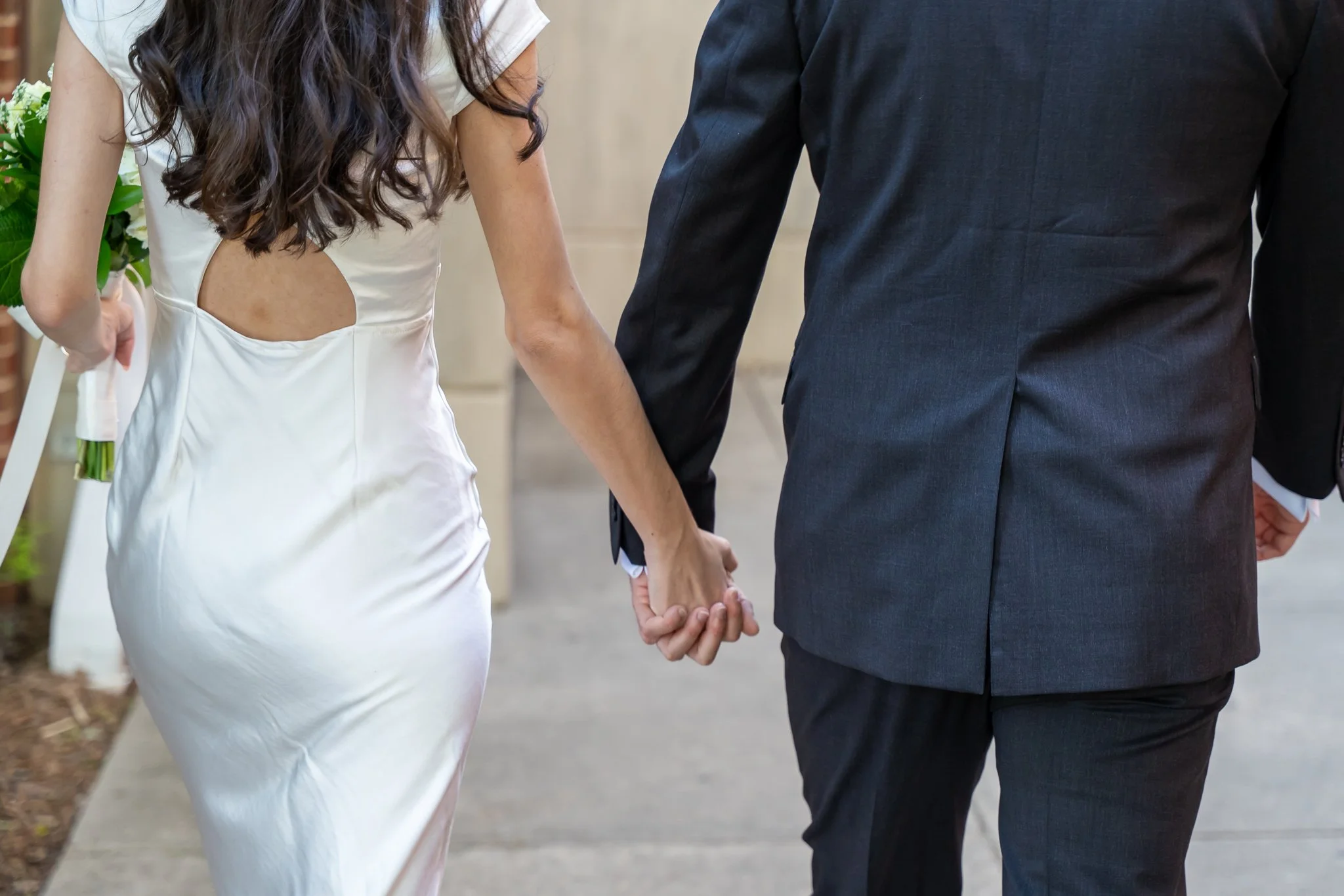 Bride and groom holding hands at Raleigh, NC wedding