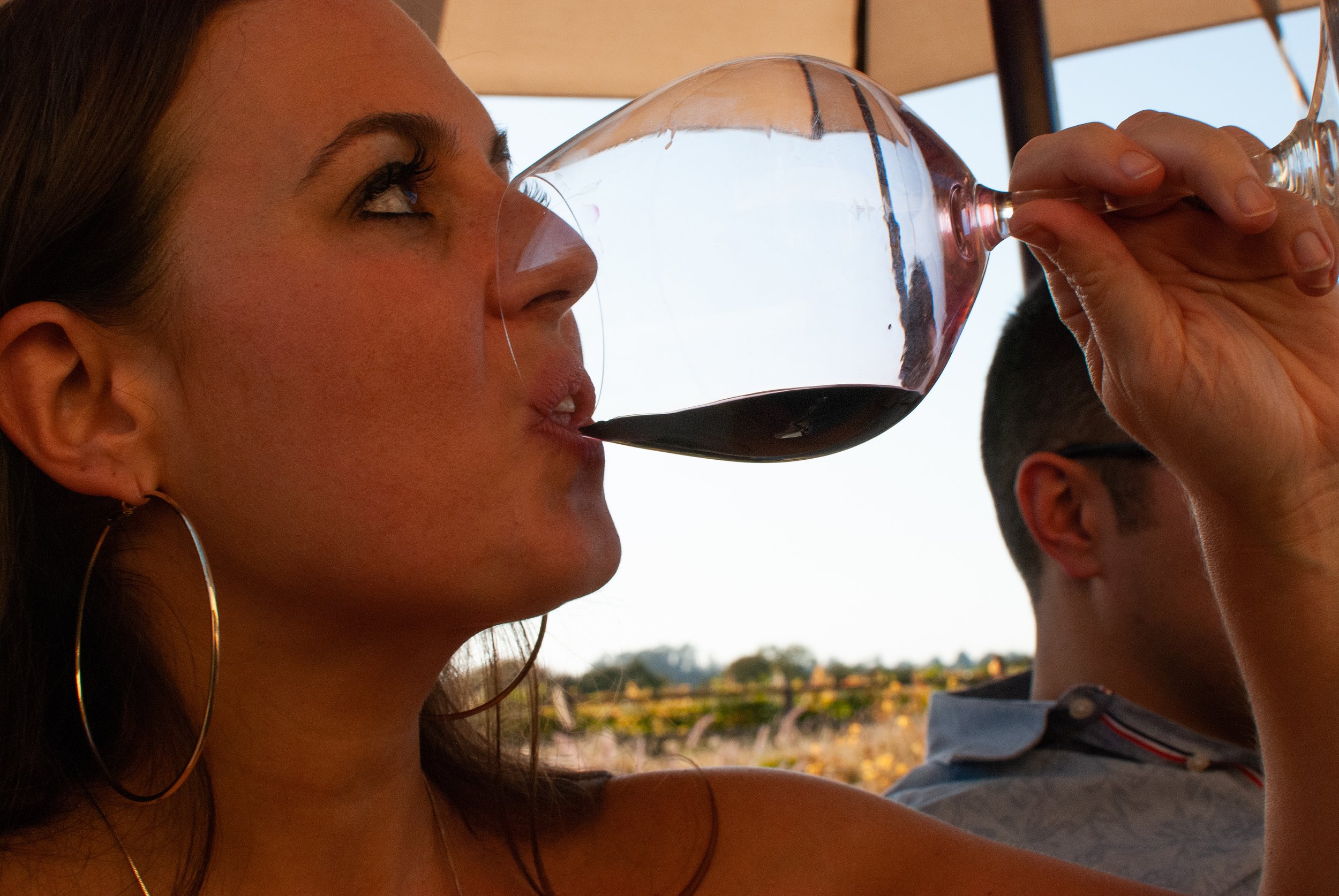 Woman drinking red wine outdoors