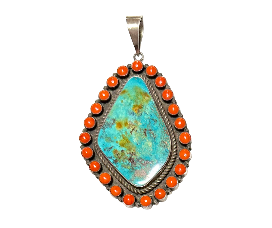 Pendant with a large turquoise stone surrounded by small orange beads, metal setting, and a metal bail for chain.