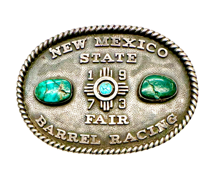 Silver belt buckle with turquoise stones engraved with 'New Mexico State Fair Barrell Racing'