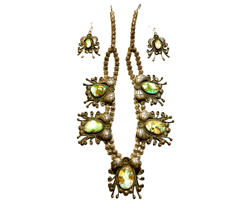 Gold-toned jewelry set including a necklace and matching earrings with large oval green and yellow gemstones and intricate floral details.