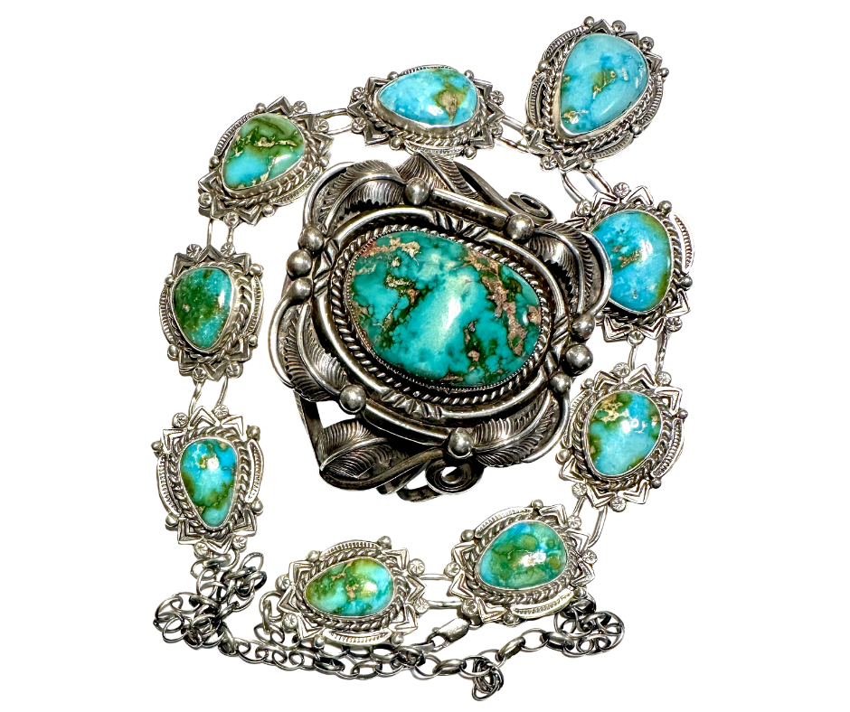 A silver jewelry set consisting of a necklace and a large brooch, each featuring turquoise stones with unique blue-green and gold veining.
