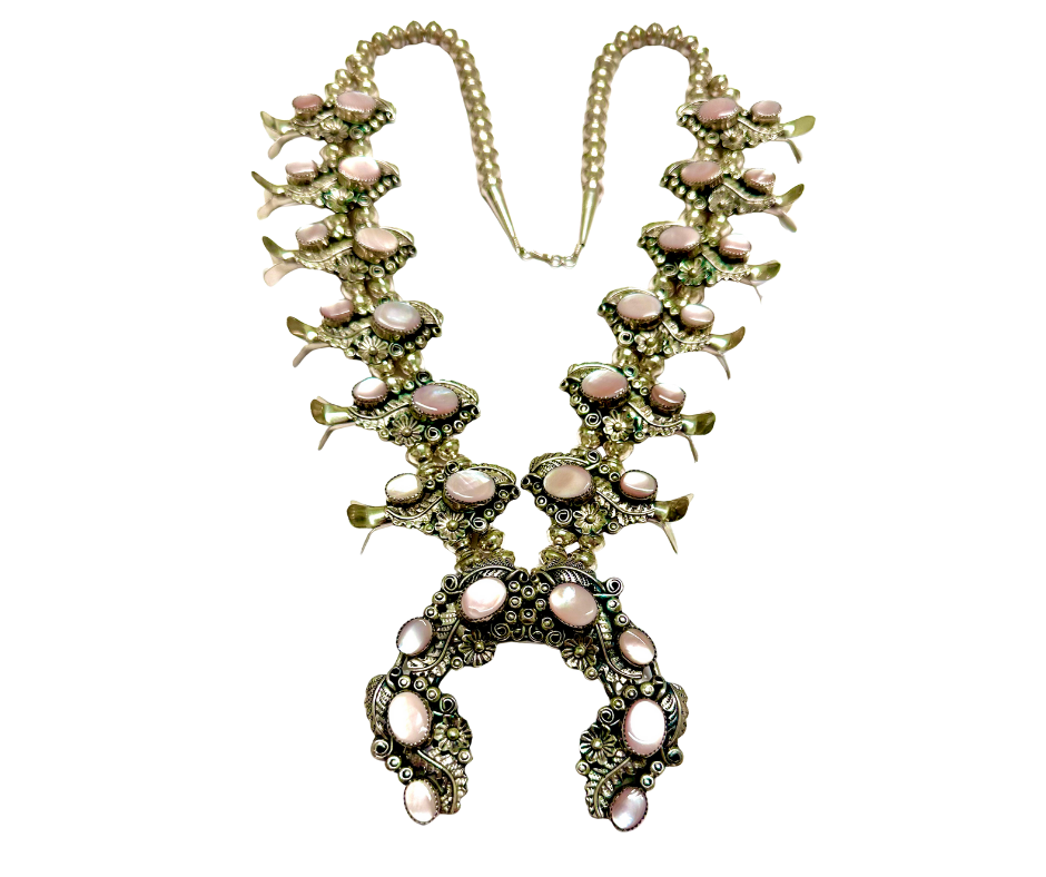 A jewelry necklace with pink gemstones and intricate metalwork design.