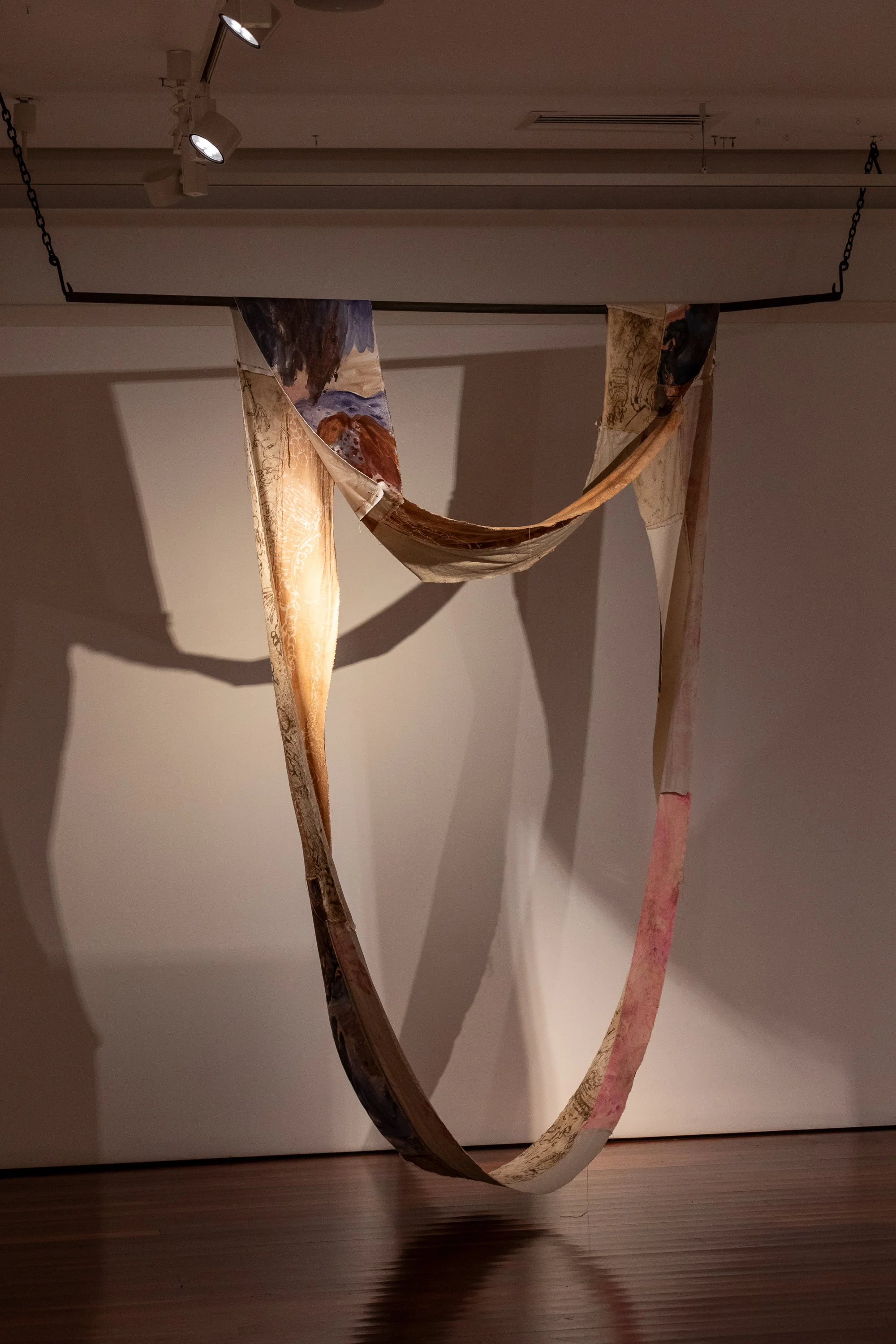 Circular systems, ground pigment on canvas, thread, botanical inks, thread, and soil on cotton. Supported by found farm steel and chains, 2900 x 2400 x 10 cm, 2025