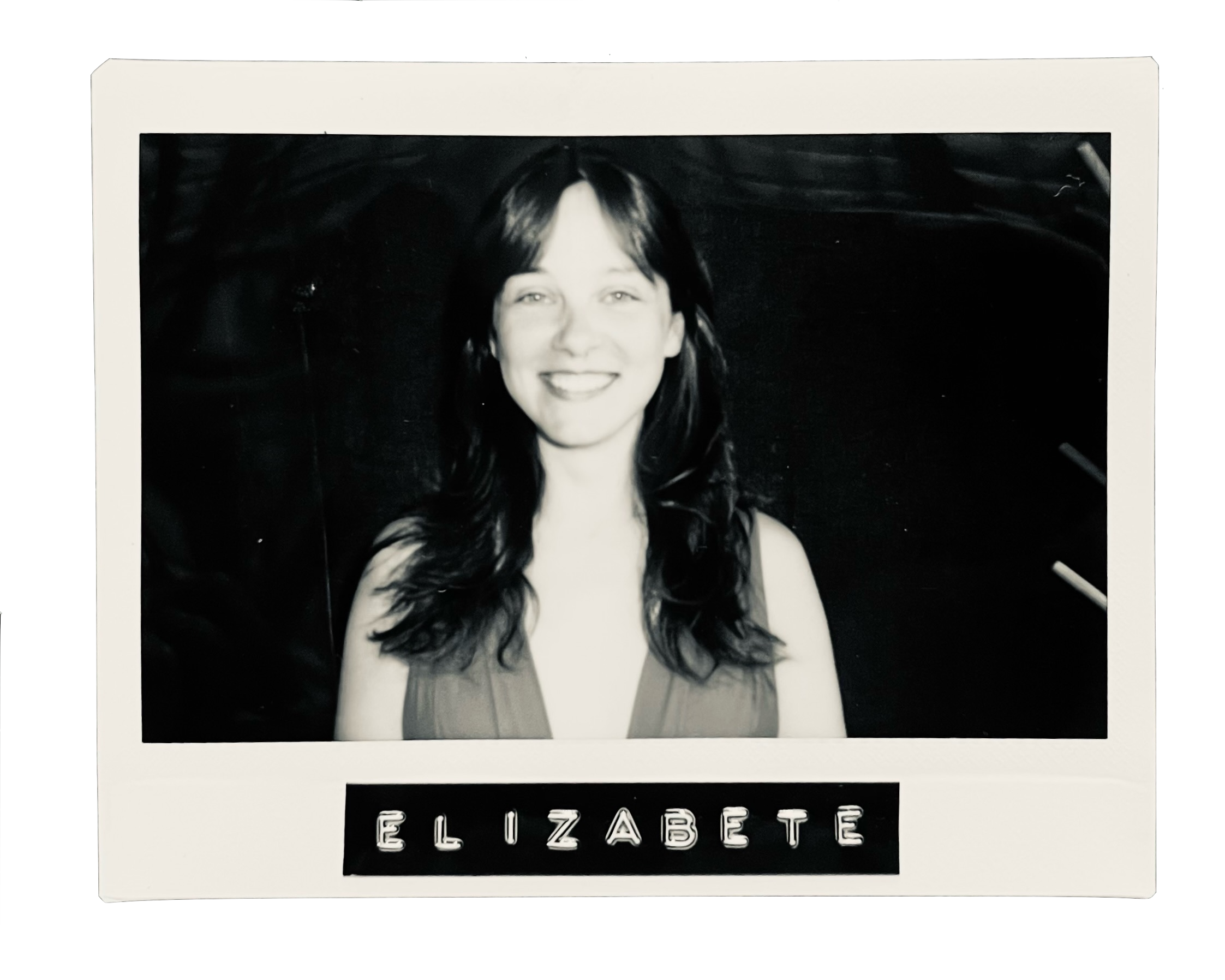 Black and white photo of a woman with shoulder-length hair, smiling, wearing a sleeveless top, with the name "ELIZABETH" written on a label beneath the photo.