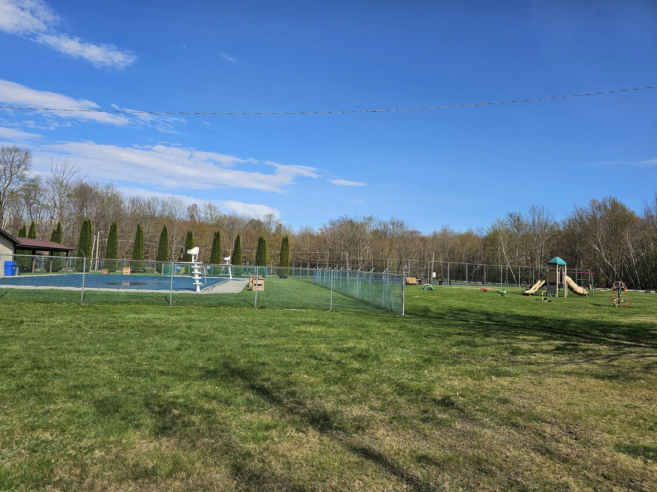 View of the Pool, playground and tennis court.